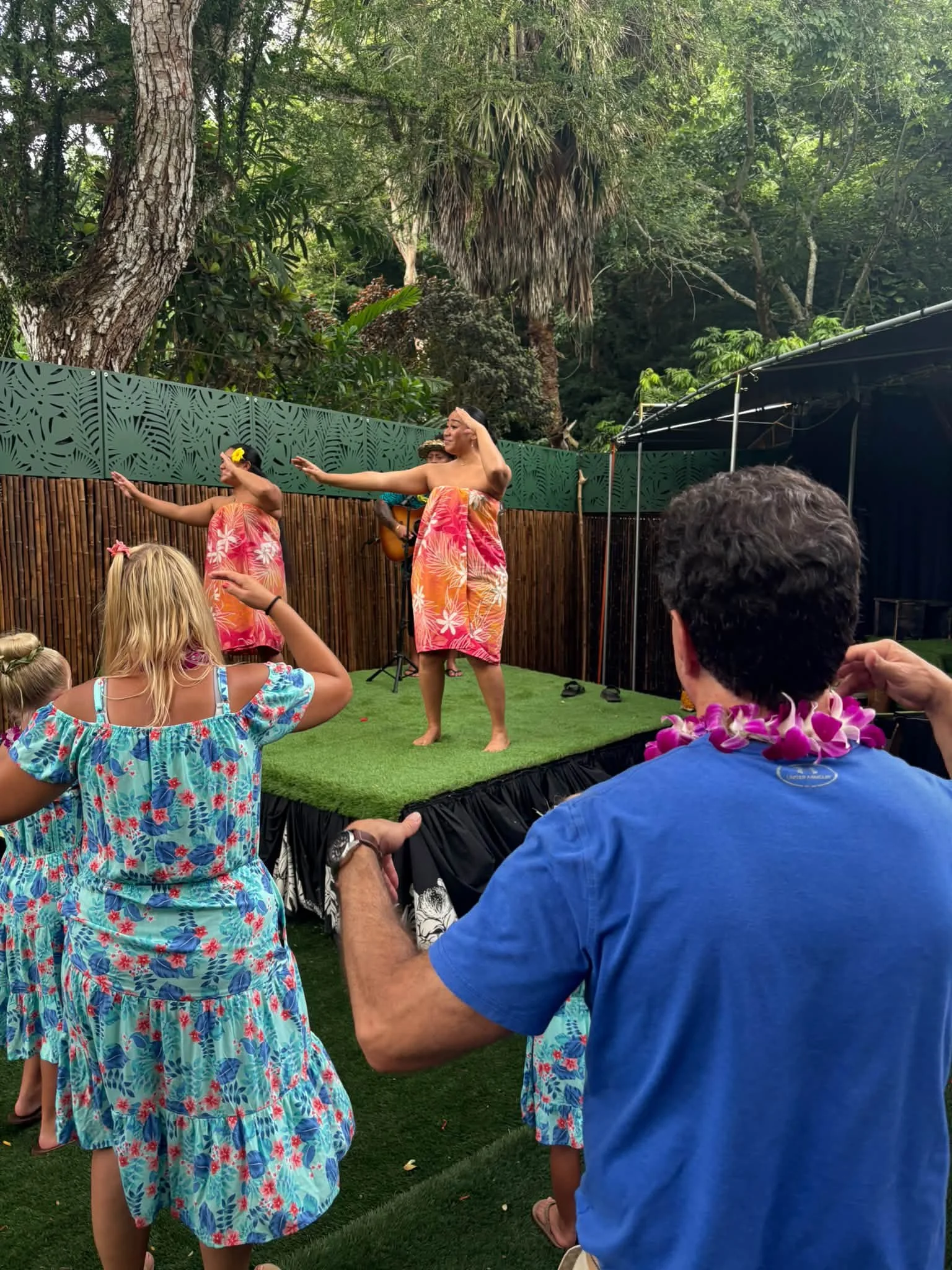 Guests watch an outdoor performance during the Hawaii outing