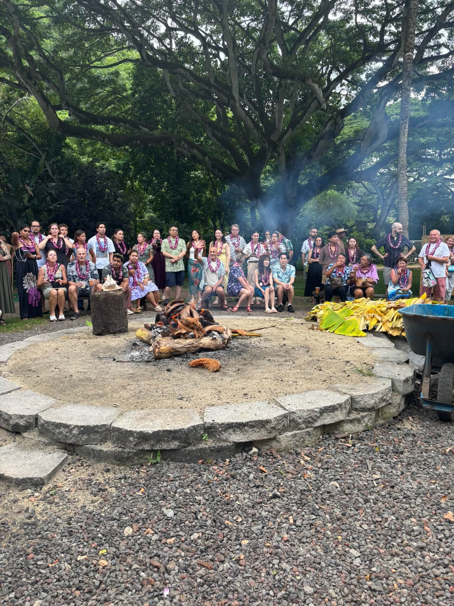 Guests gather around an outdoor demonstration area in Hawaii