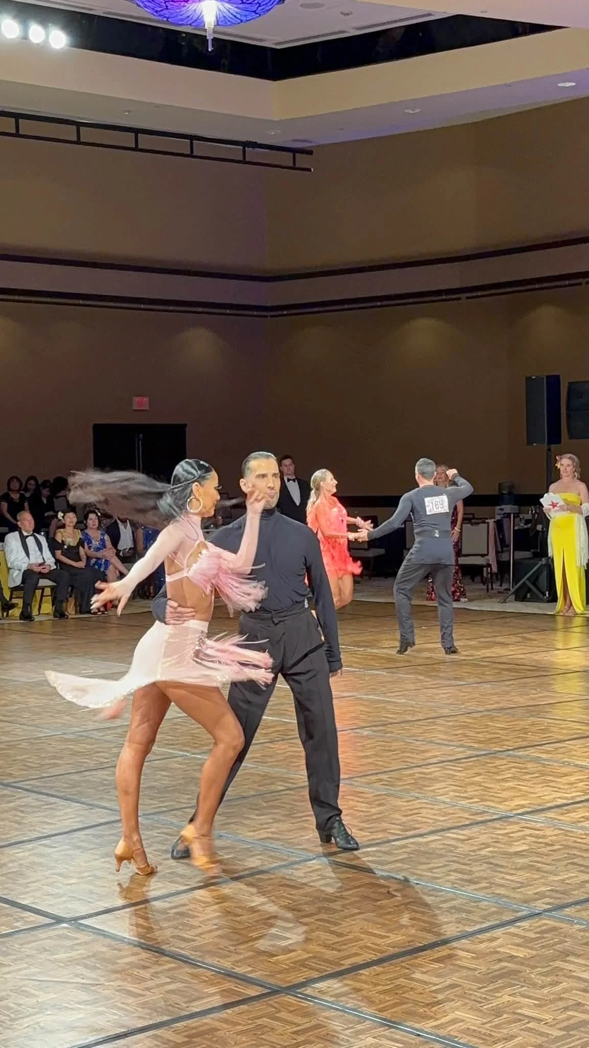 A couple in pink and black dances at Hawaii Star Ball