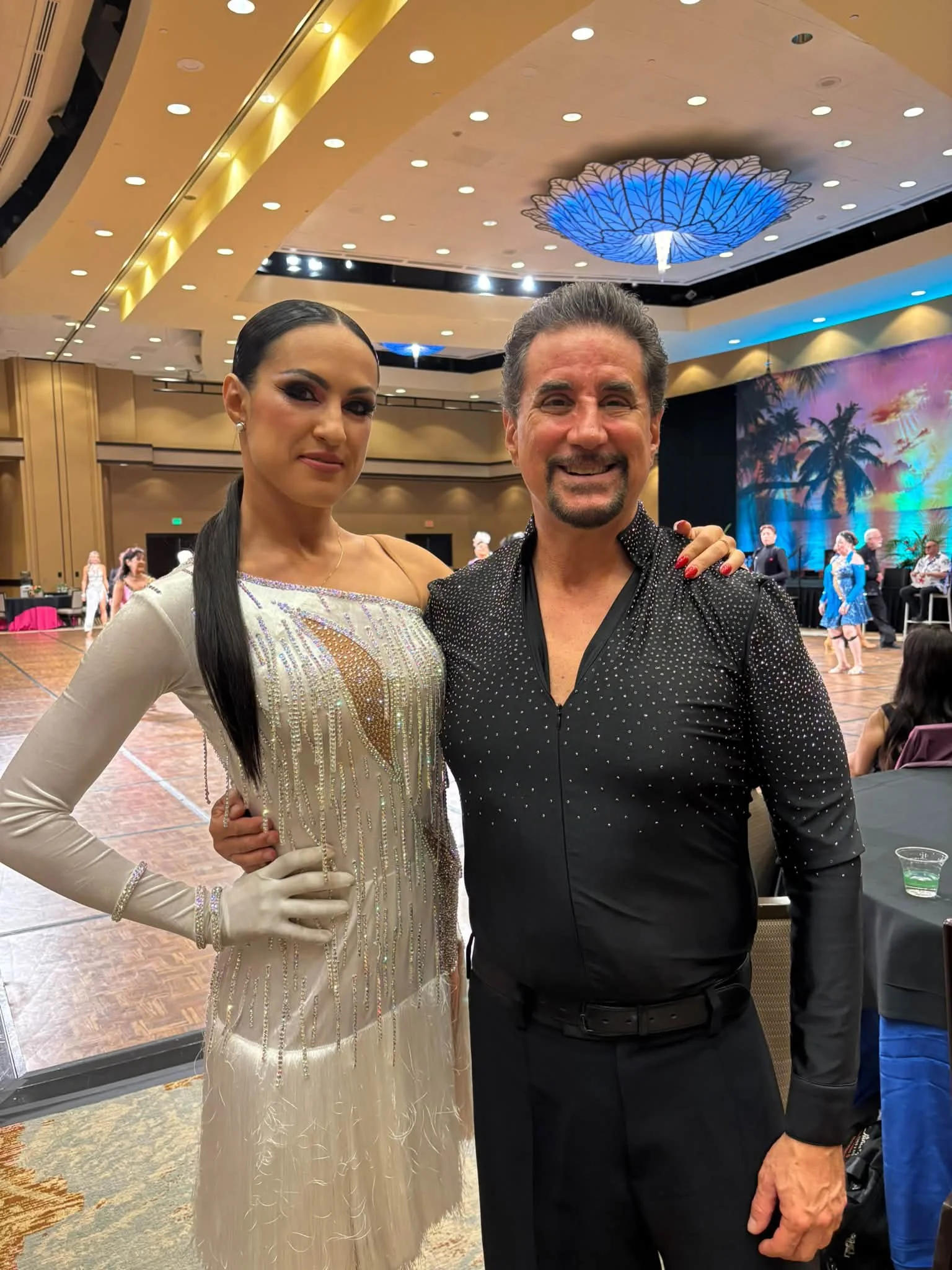 A Dance Fire competition pair poses in silver and black attire