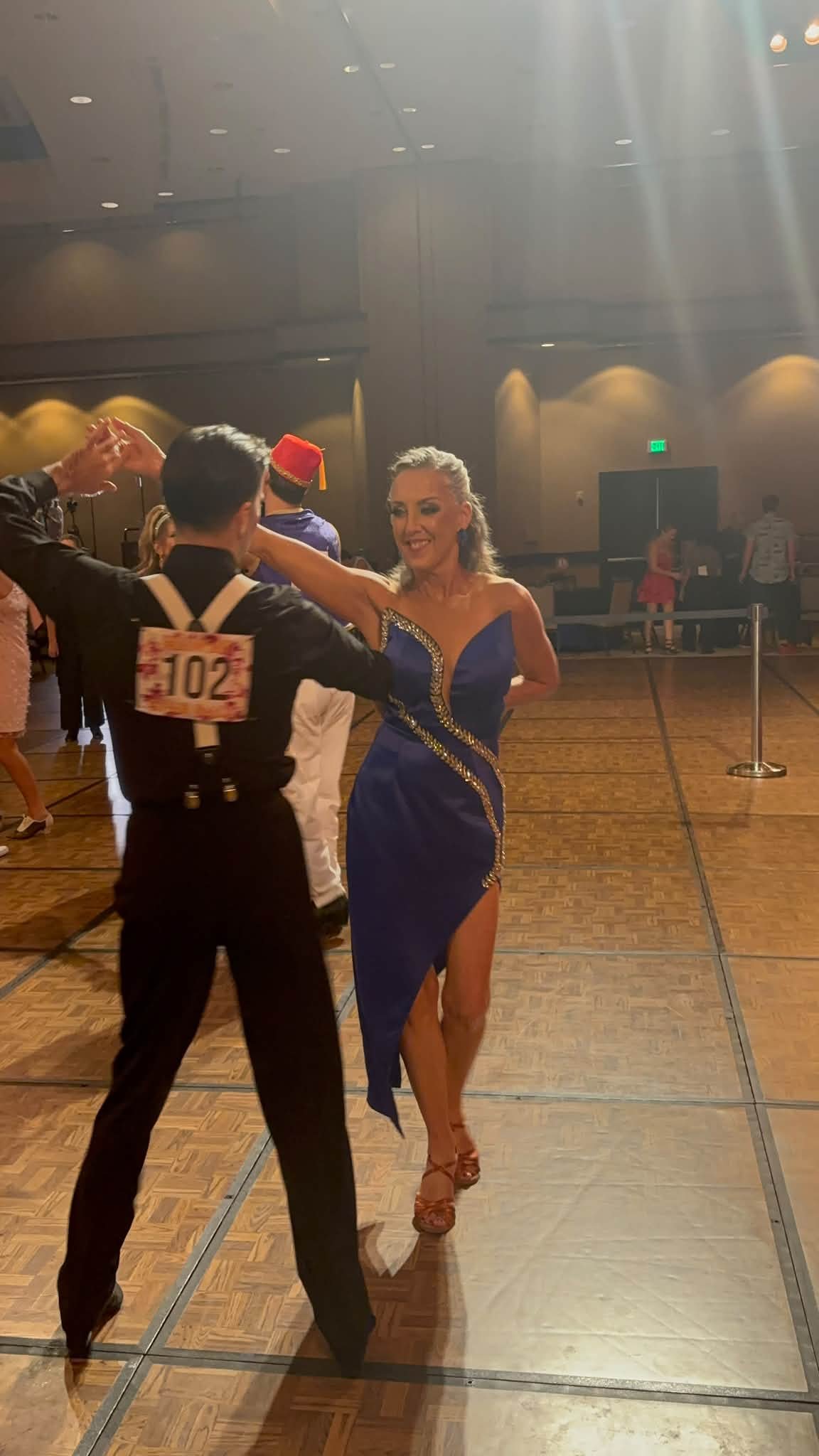 A competition pair displays an award during the Hawaii Star Ball weekend