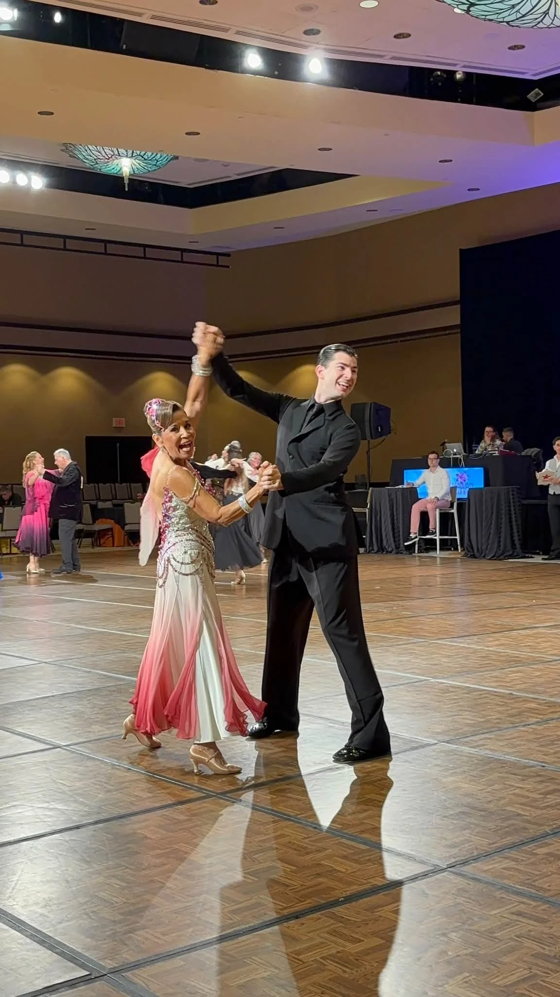 A ballroom couple in pink and black dances at Hawaii Star Ball