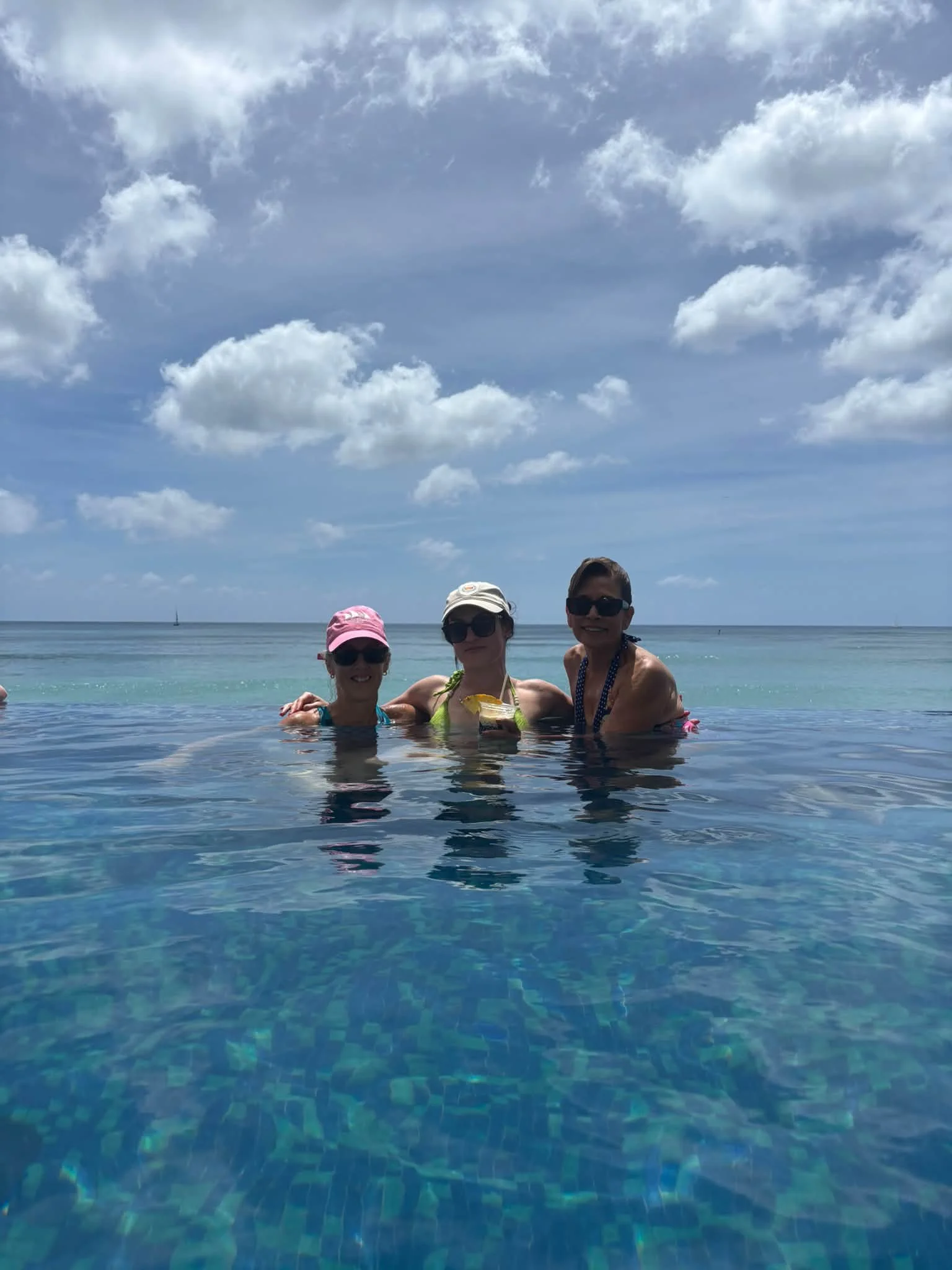 Dance Fire travelers relax in a pool overlooking the ocean