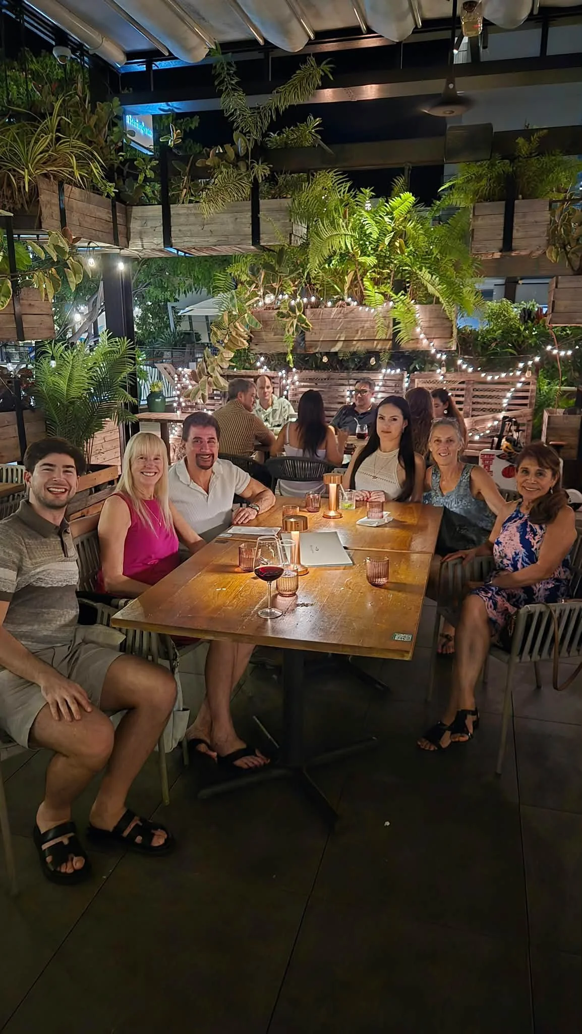 Dance Fire travelers share dinner at an outdoor table in Hawaii