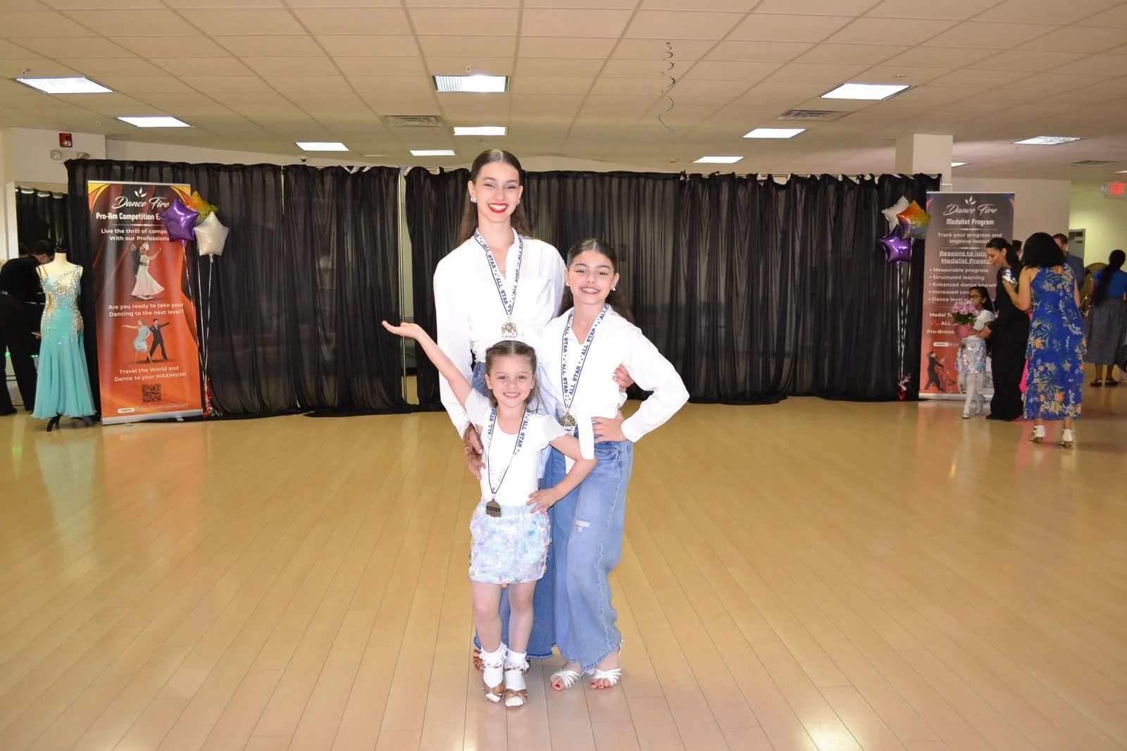 Young recital participants pose together on the studio floor