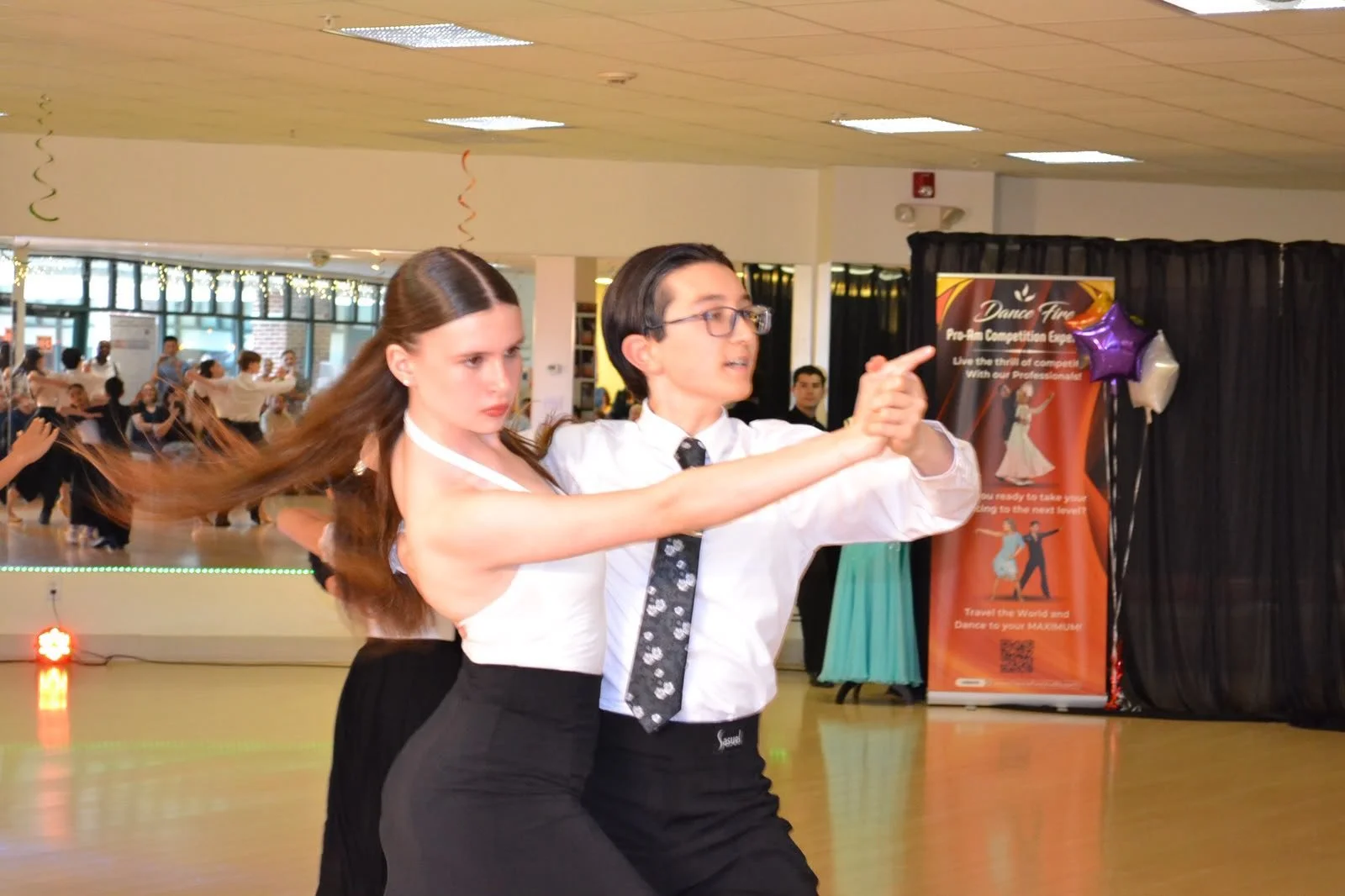 Two young dancers perform a partnered routine at the youth recital