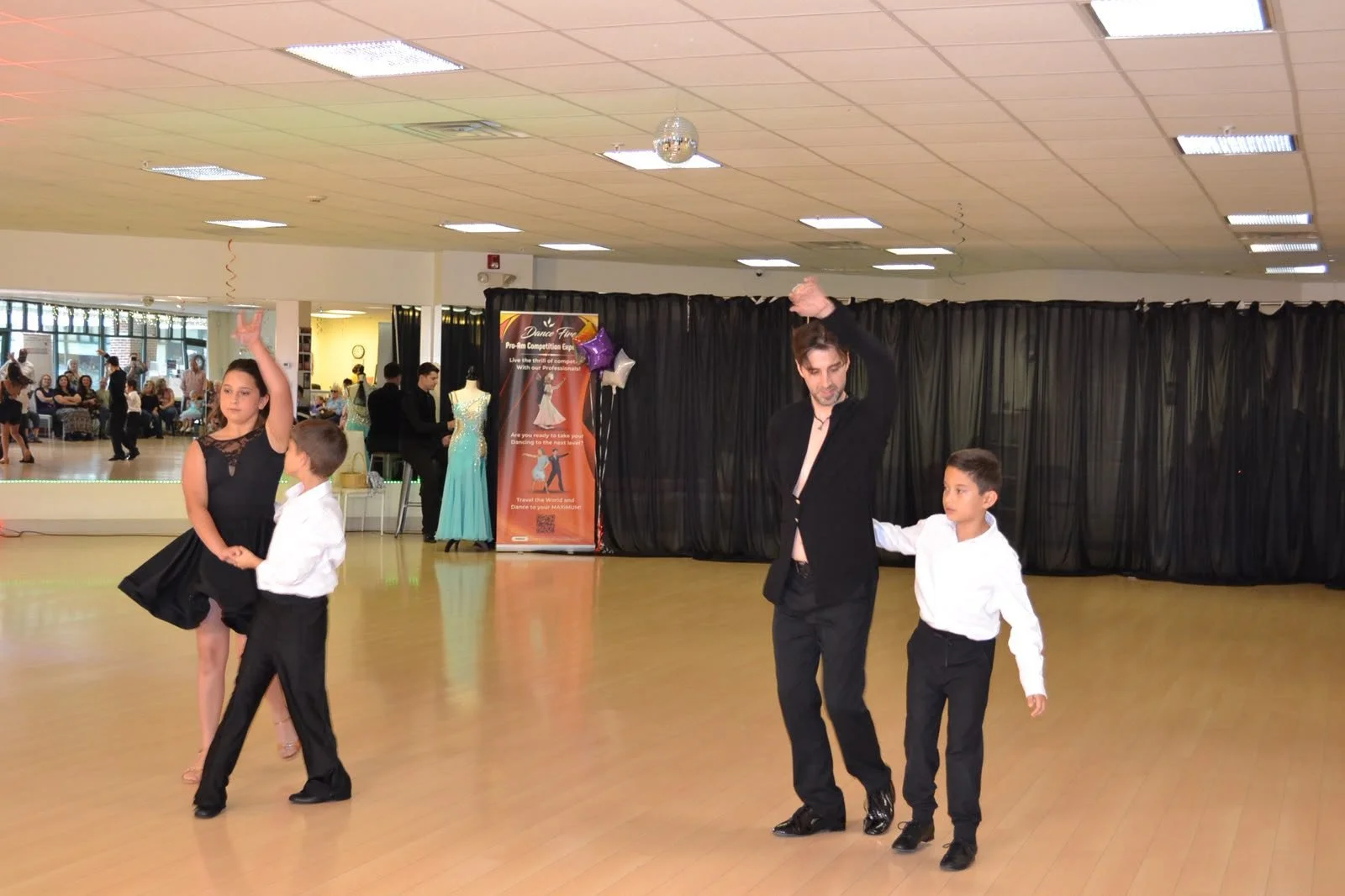 An instructor and young performers share the recital floor