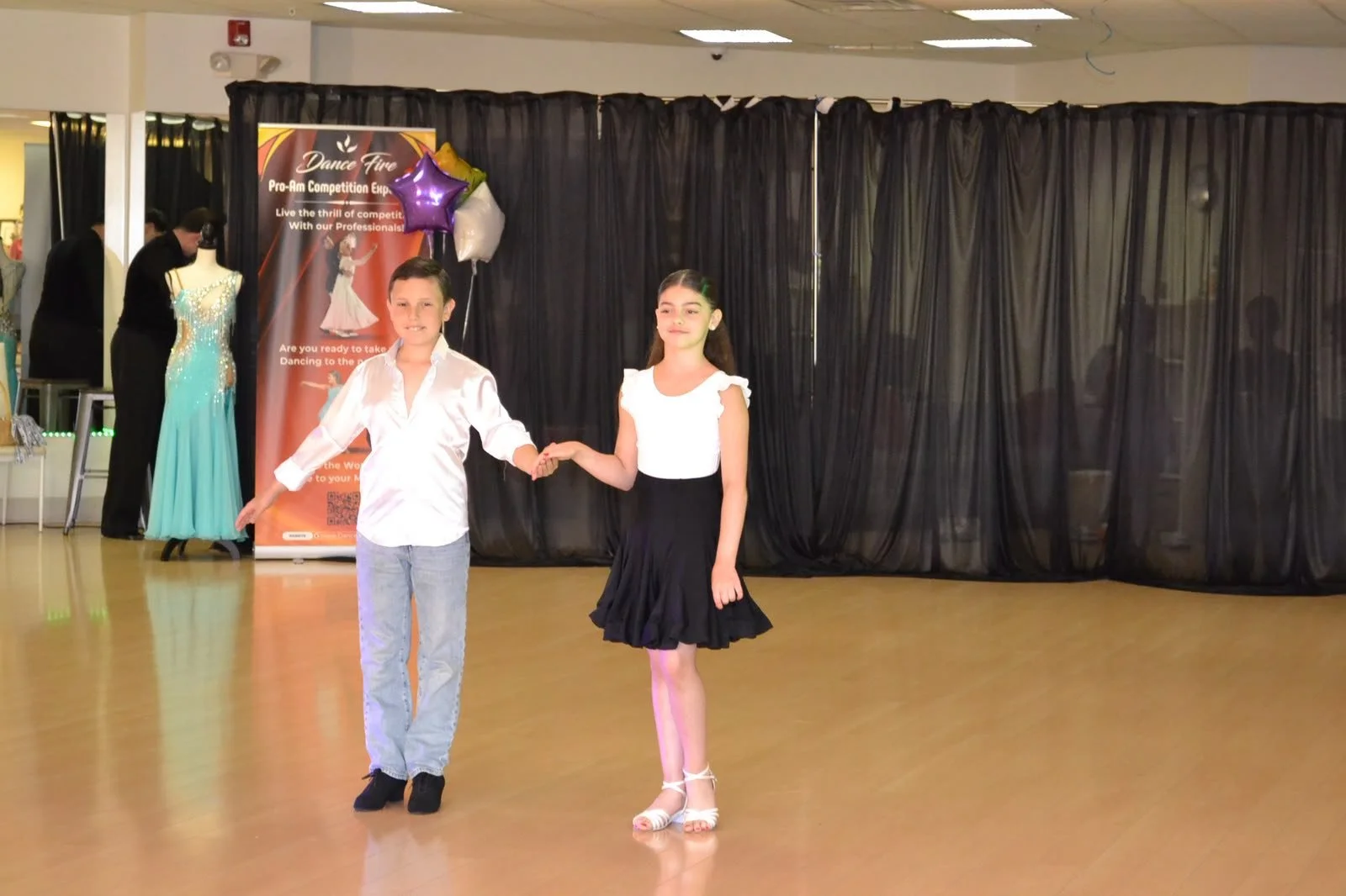 Two young dancers perform side by side during the spring recital