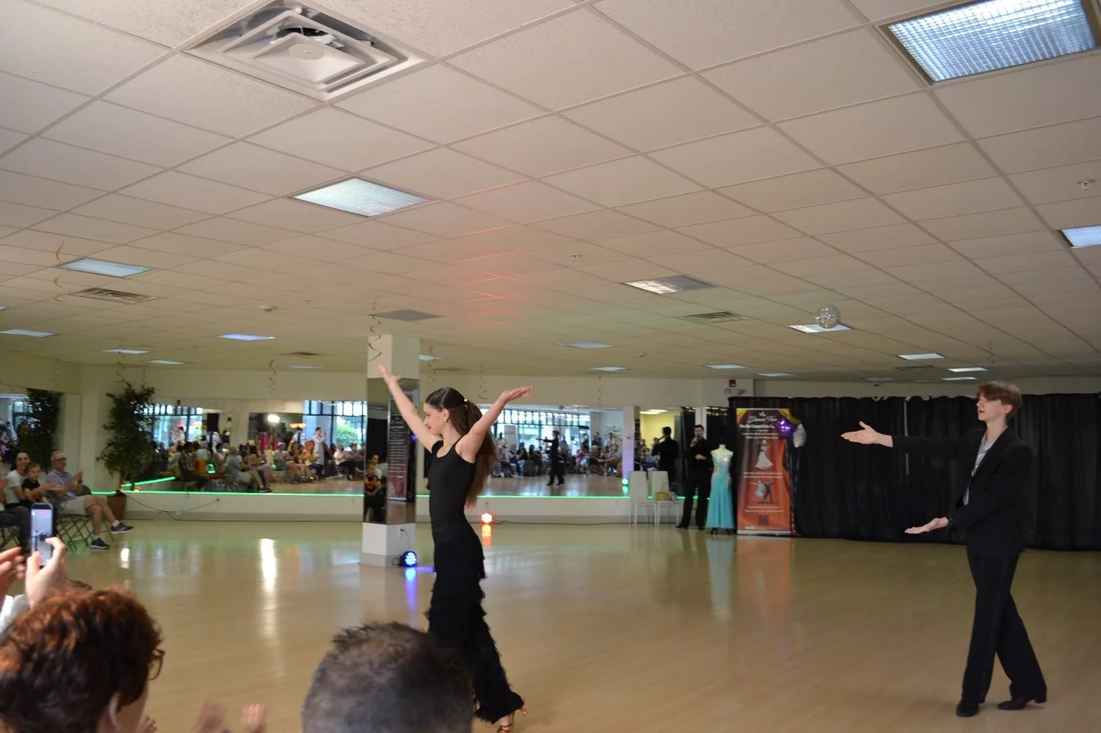 A wide view of young performers and the seated recital audience