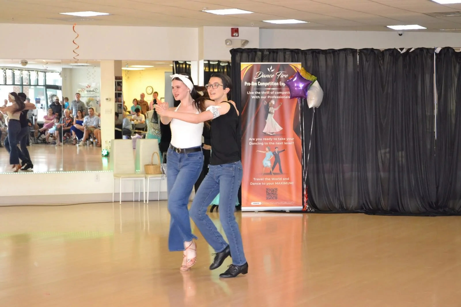 A young dance pair turns in hold during the recital