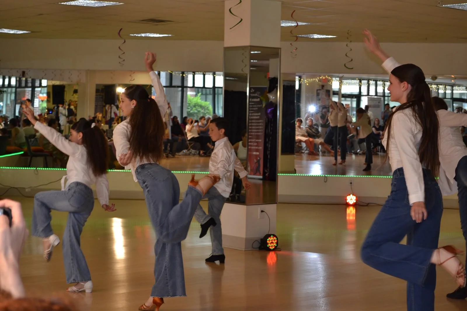 Young dancers move across the studio floor during their group routine