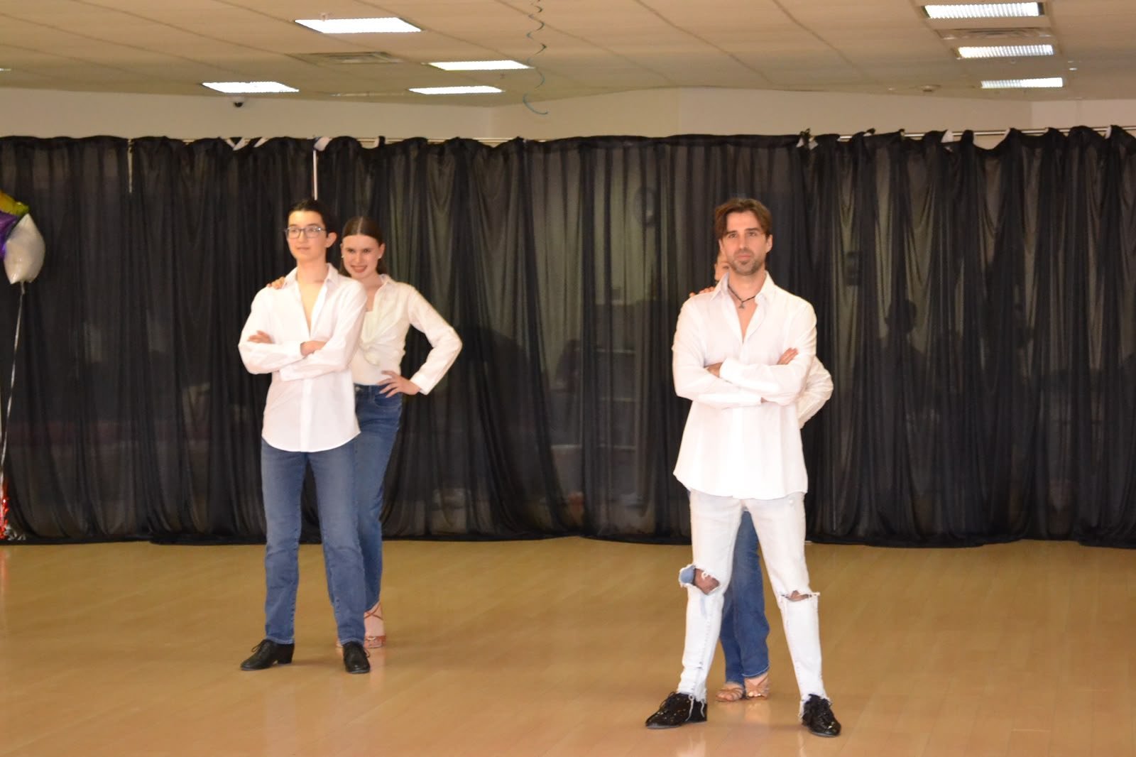 Two young performers share a recital moment in white shirts and jeans