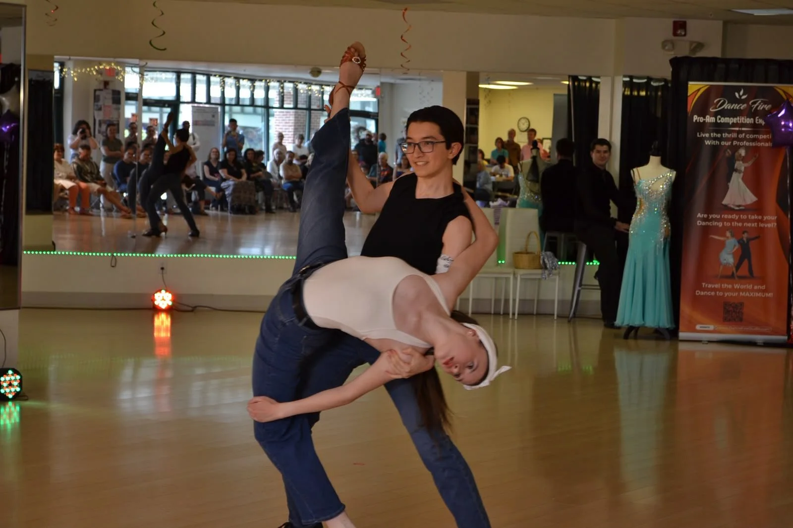 Two young performers hold a partnered dip during the recital
