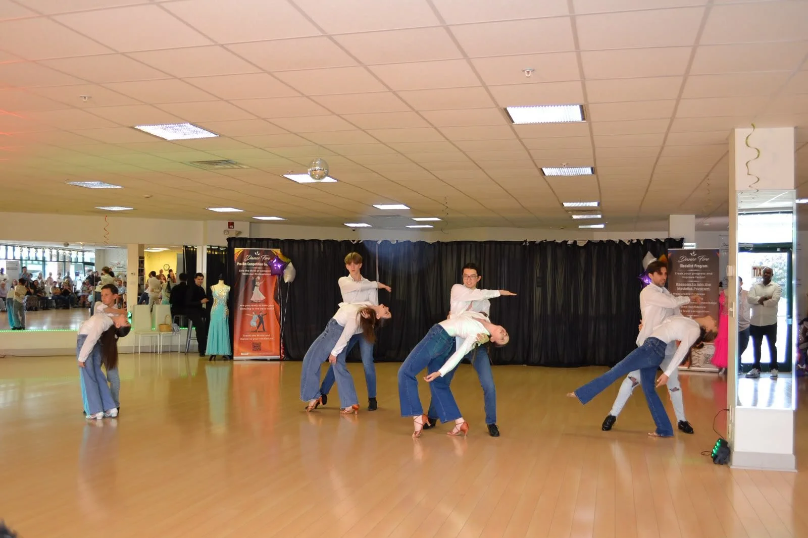 Youth performers move together across the studio in their group recital routine