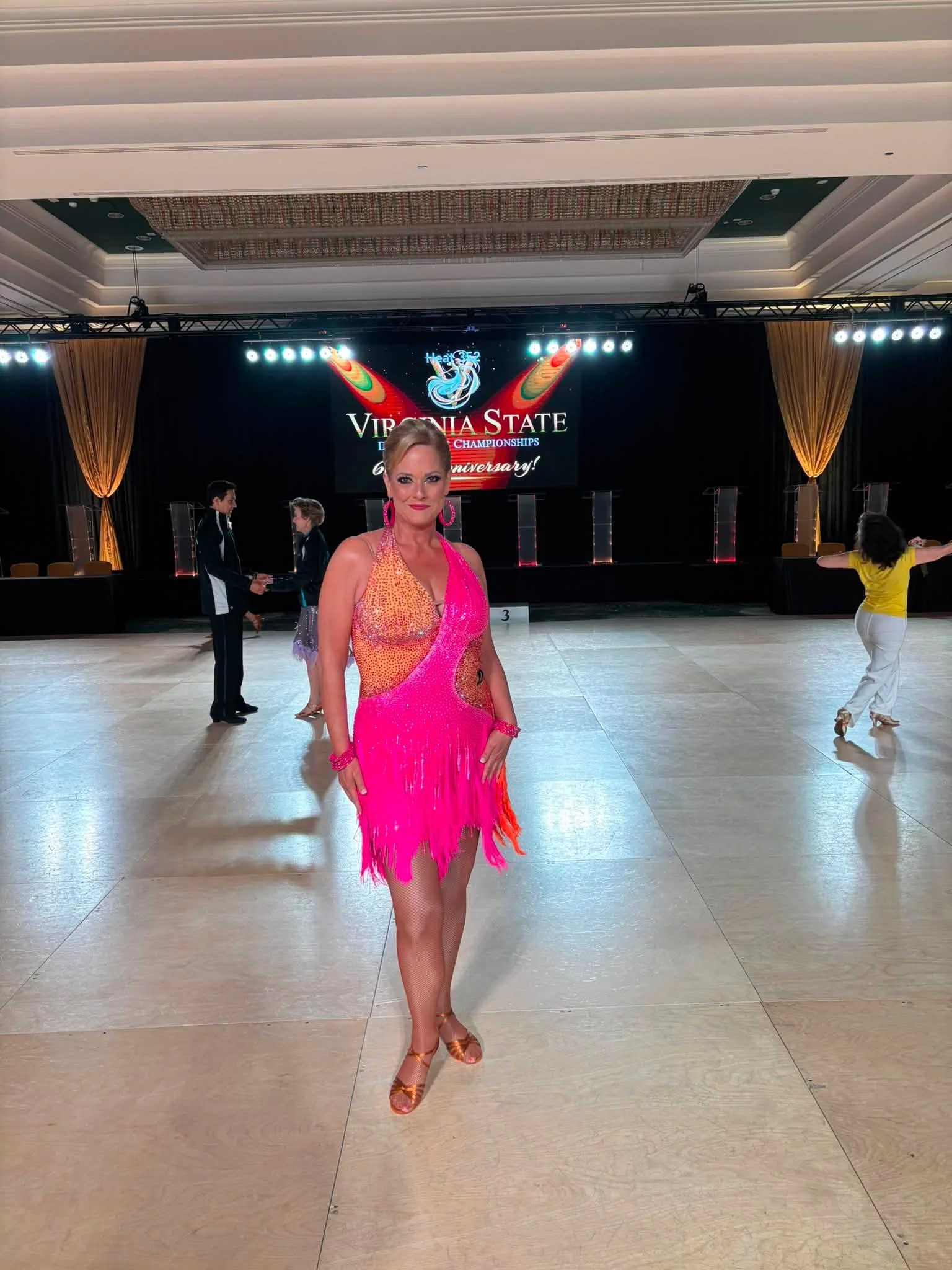 A dancer in pink performs on the Virginia DanceSport floor