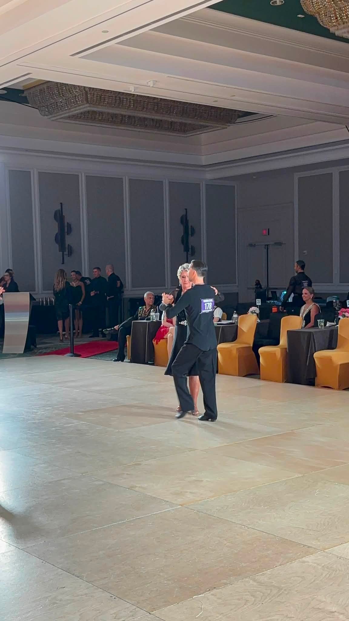 A dancer waits on the Virginia DanceSport competition floor