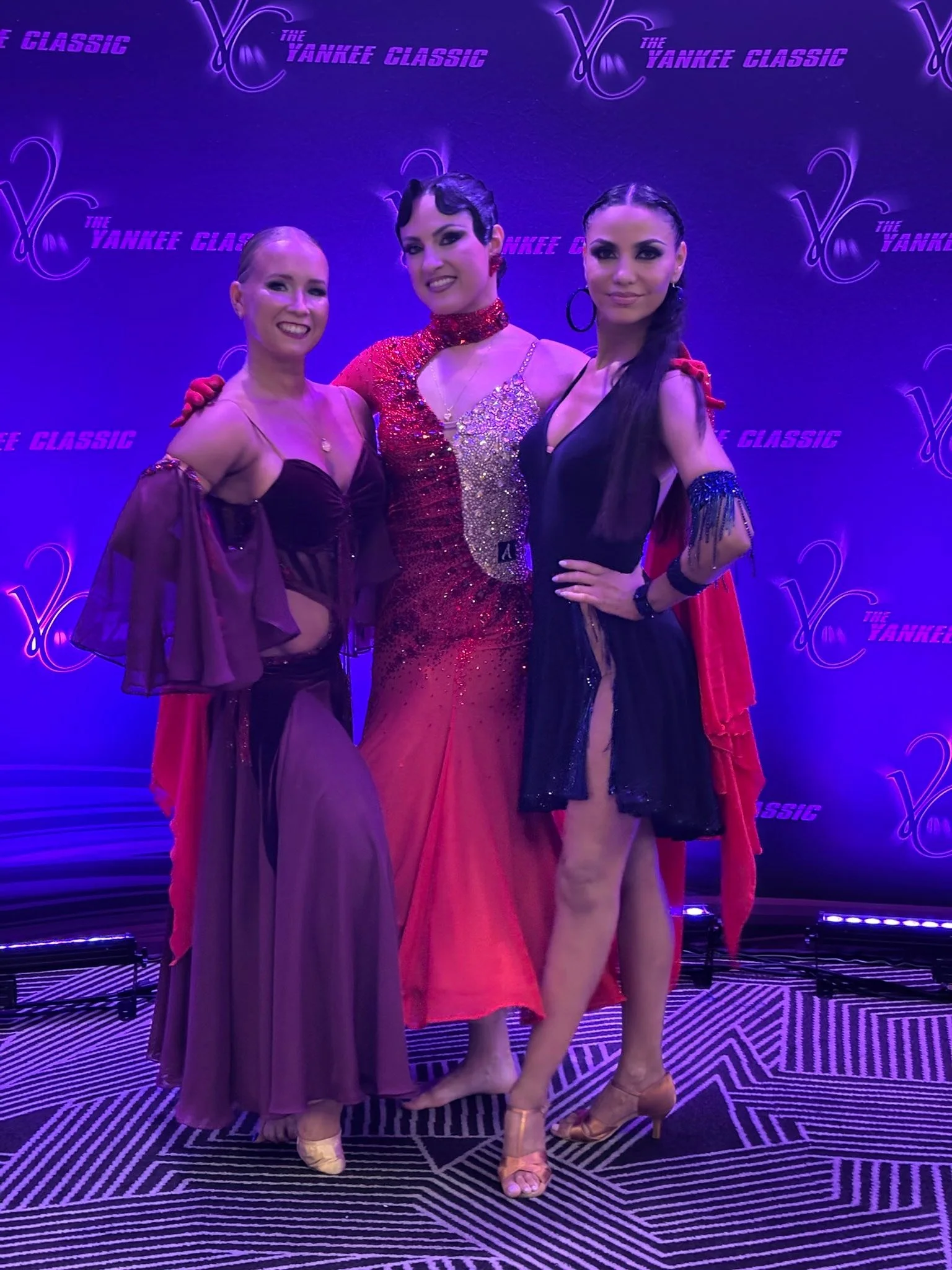 Dancers in competition attire gather for a Yankee Classic portrait