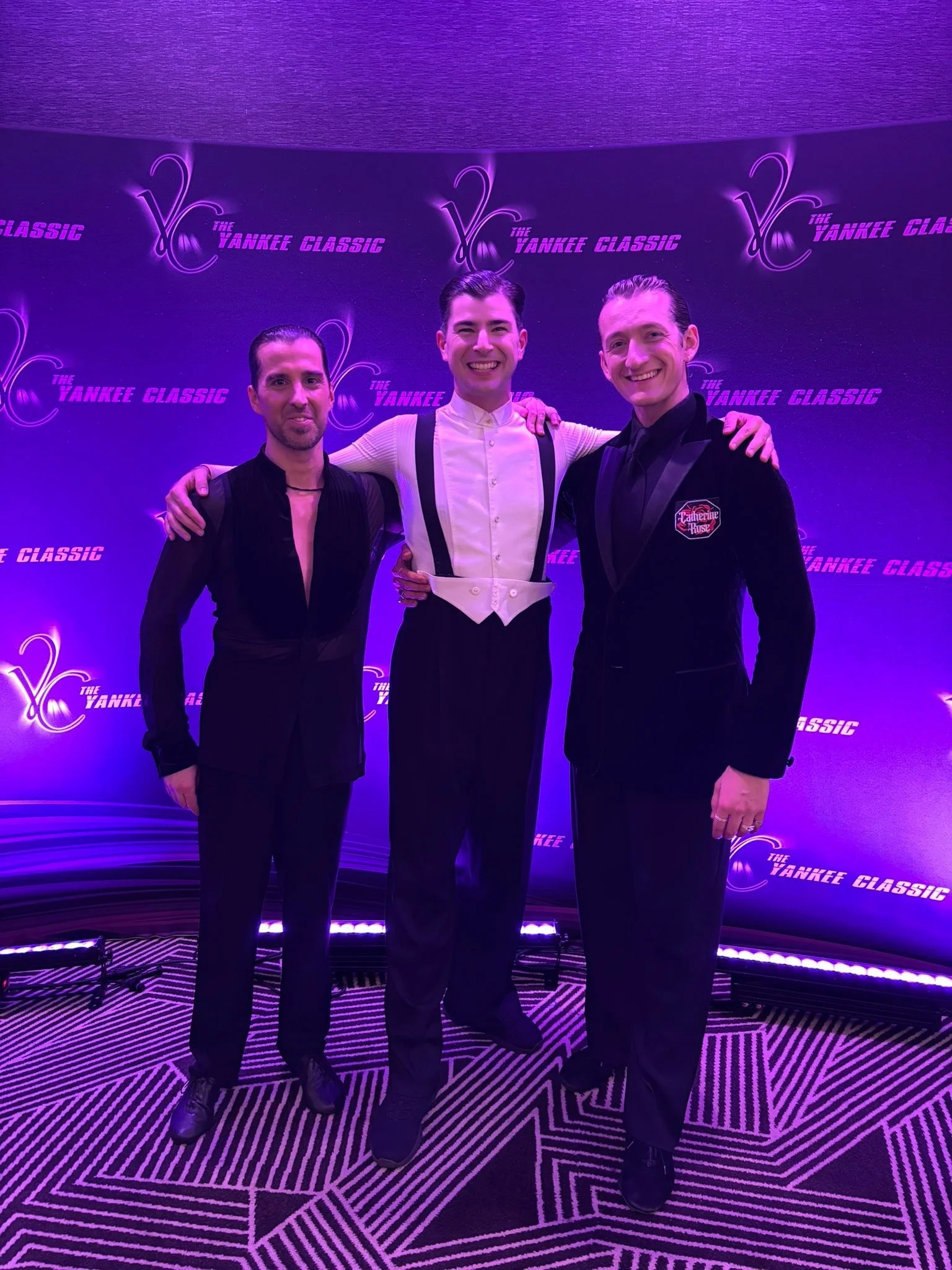 Dance Fire’s team members pose in formal attire at Yankee Classic
