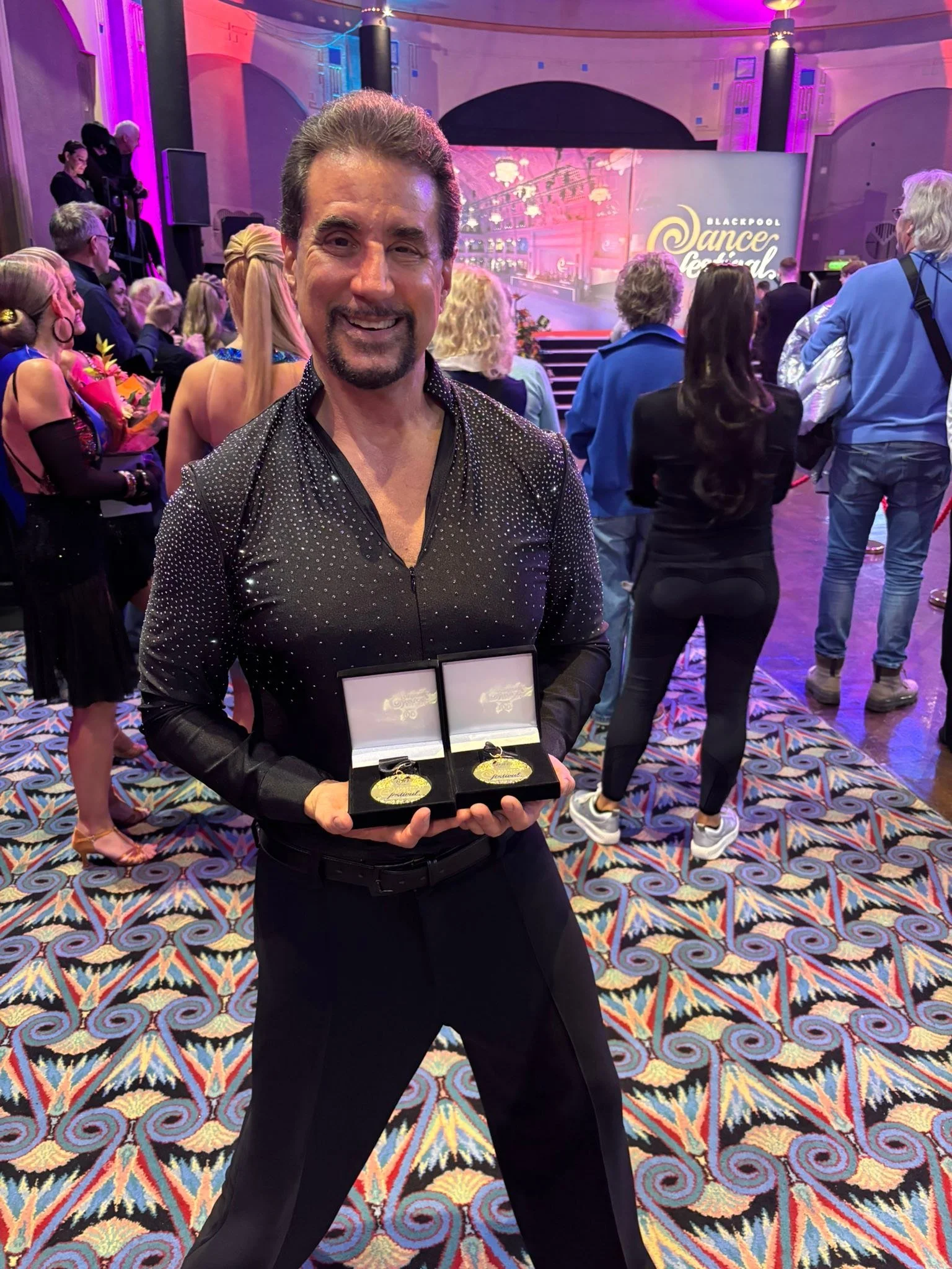 A Dance Fire competitor displays medals during the Blackpool festival