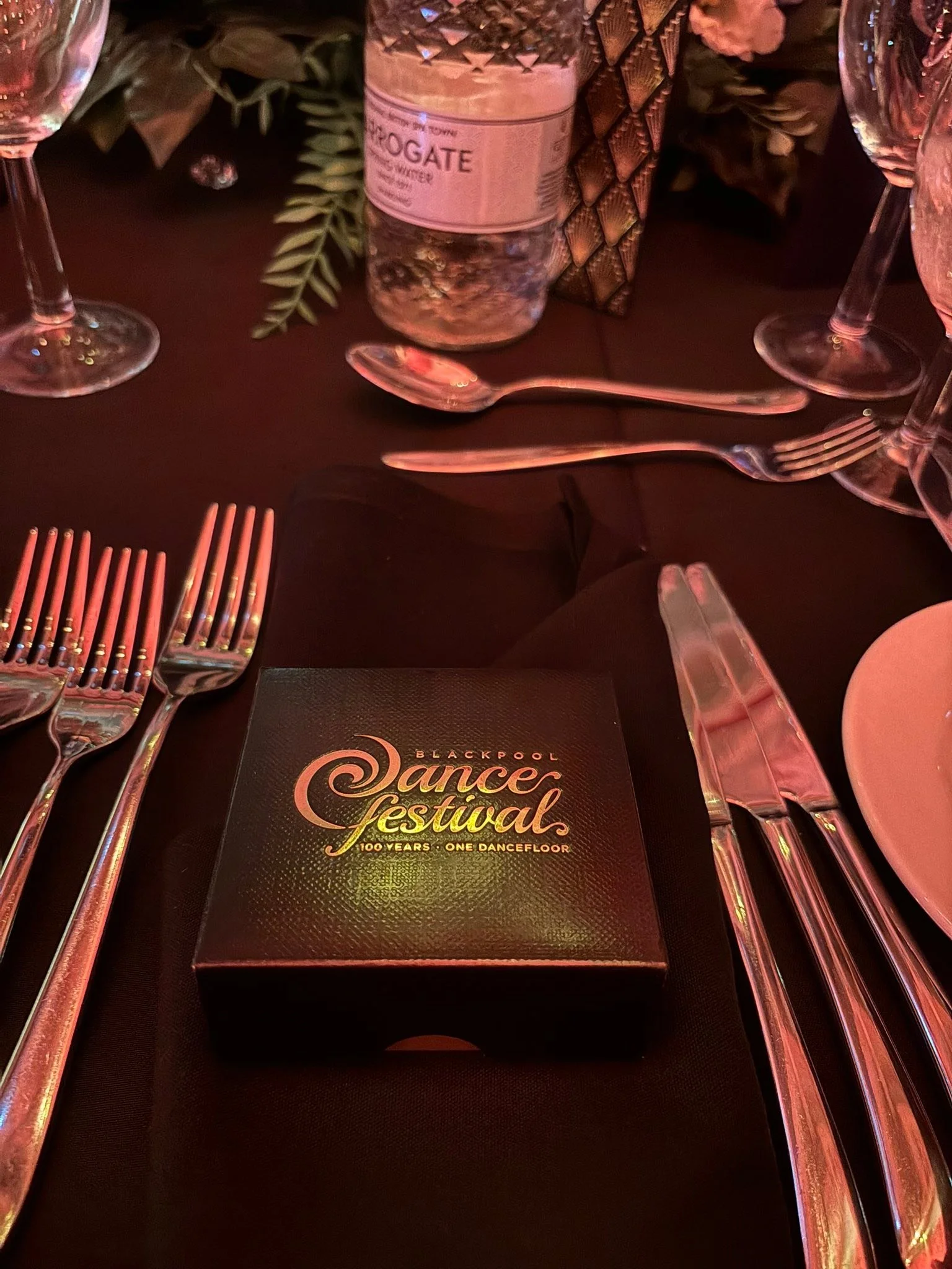 A Dance Festival program rests at a gala dinner place setting