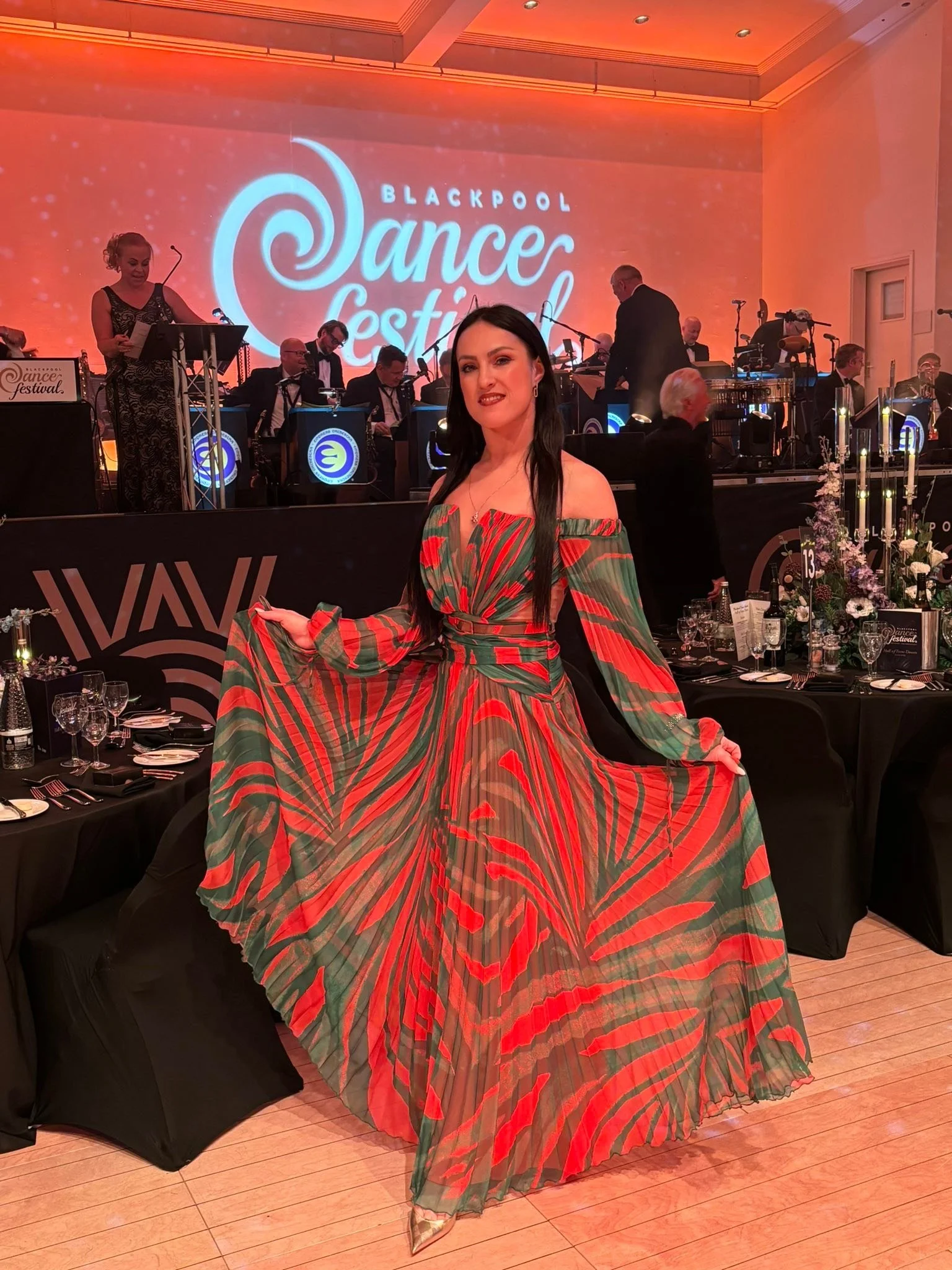 A Dance Fire participant poses in a patterned gown inside the gala ballroom