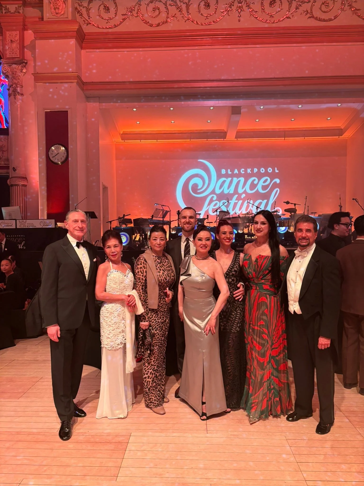 A group of gala guests gathers for a portrait inside the Blackpool ballroom