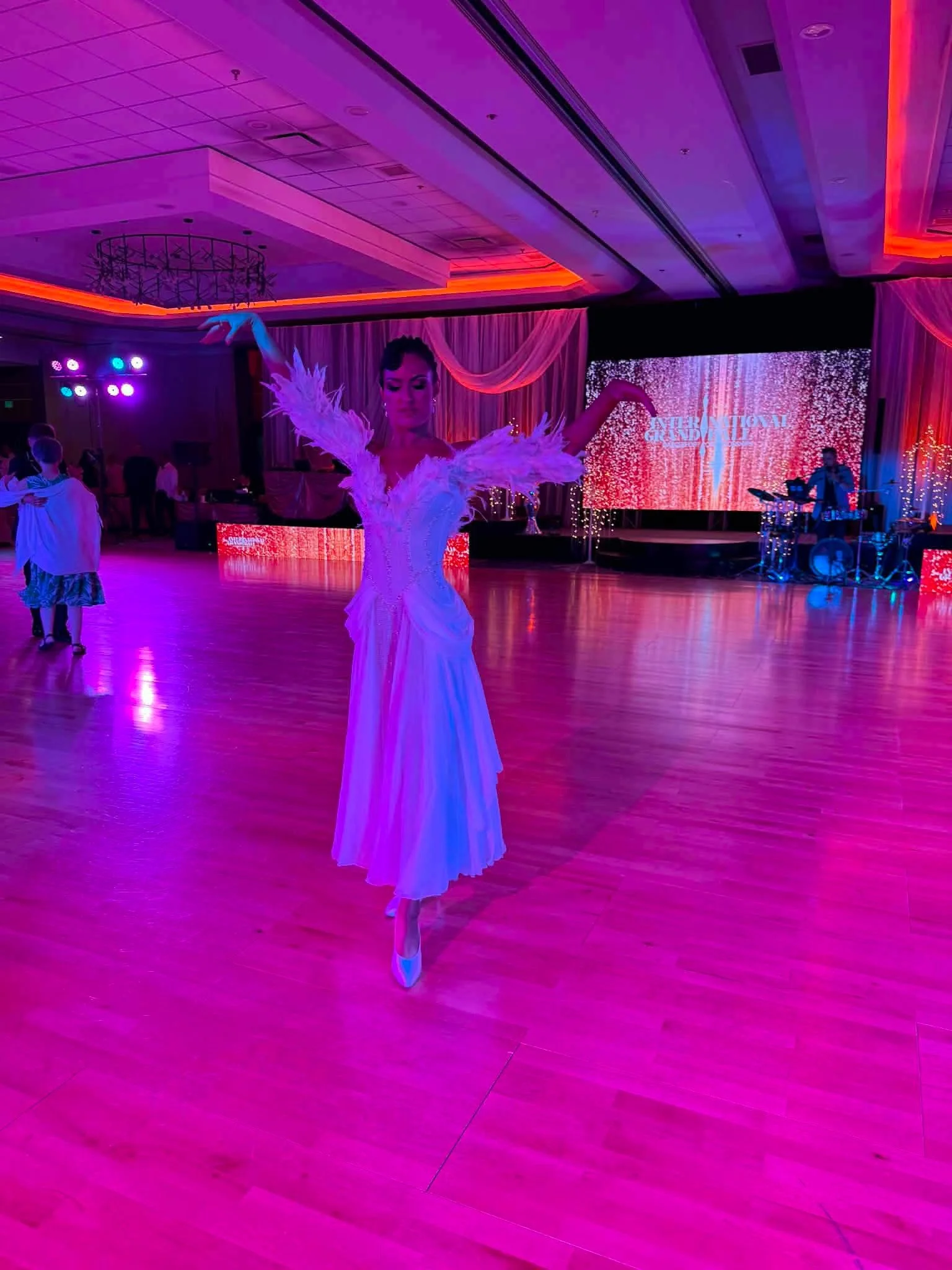 Natalia on the competition dance floor under purple lighting