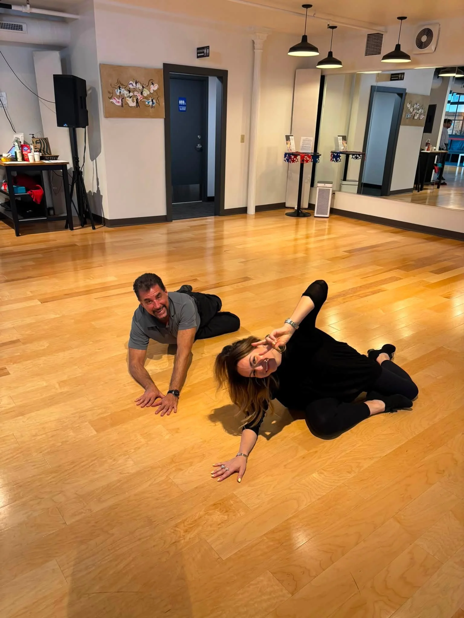 Two coaching participants practice floor exercises at Dance Fire