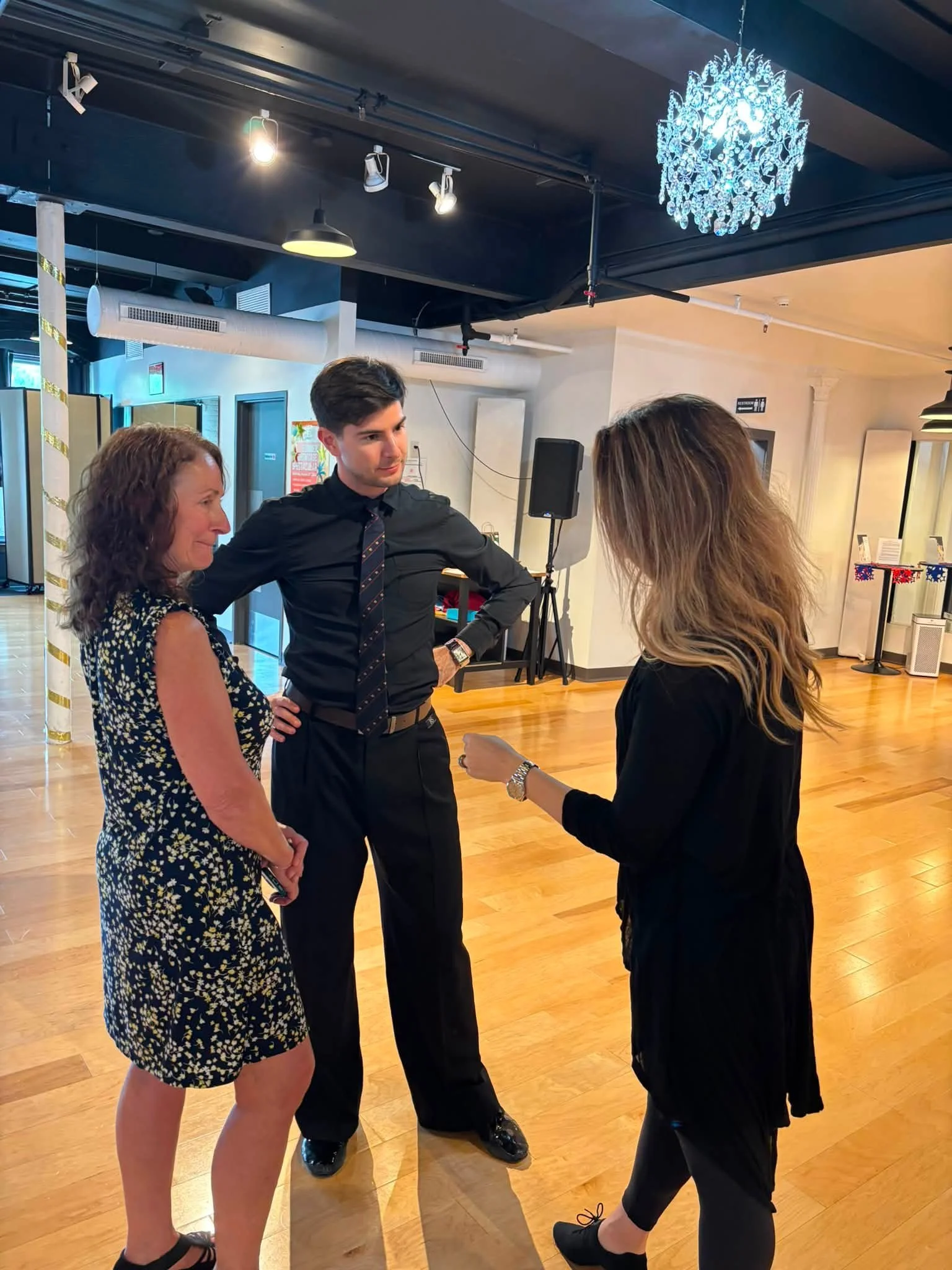 Dancers discuss partnered movement during a coaching session