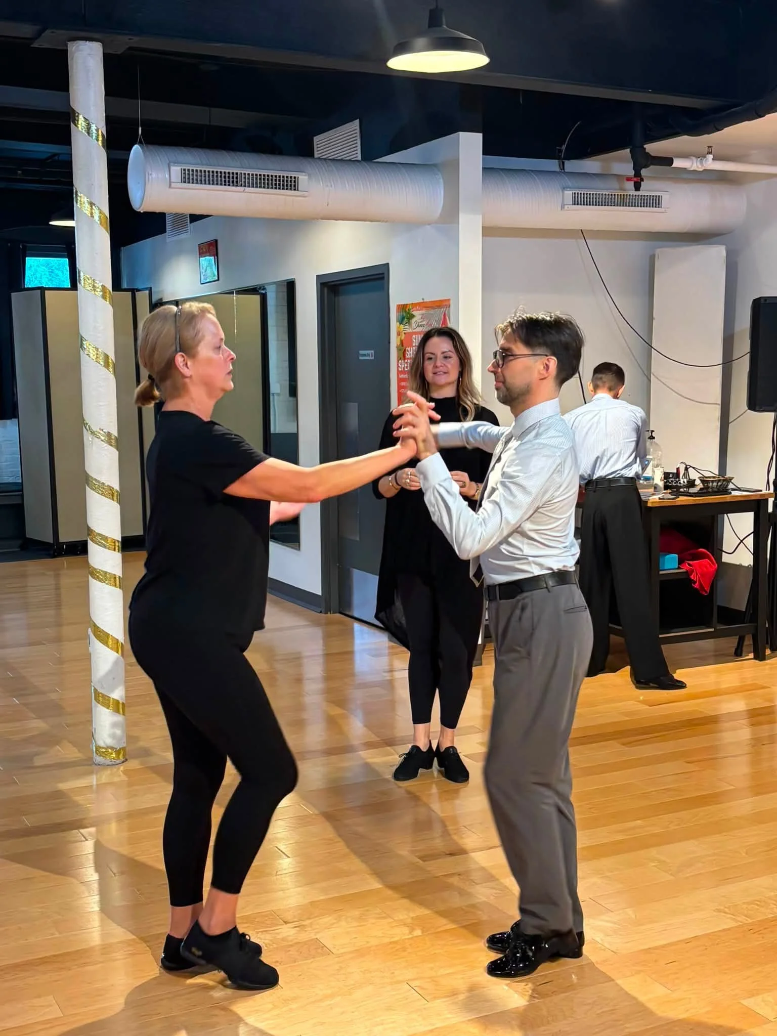 A couple practices their dance hold during the coaching visit