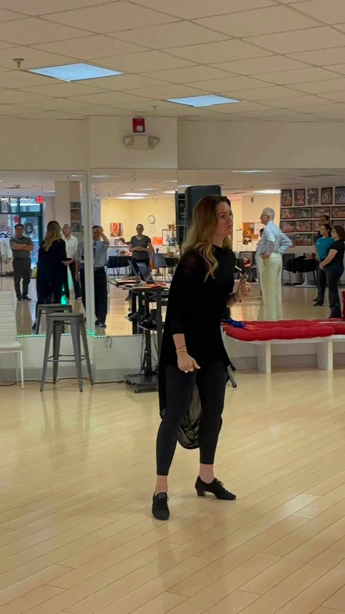 An instructor demonstrates movement on the Dance Fire studio floor