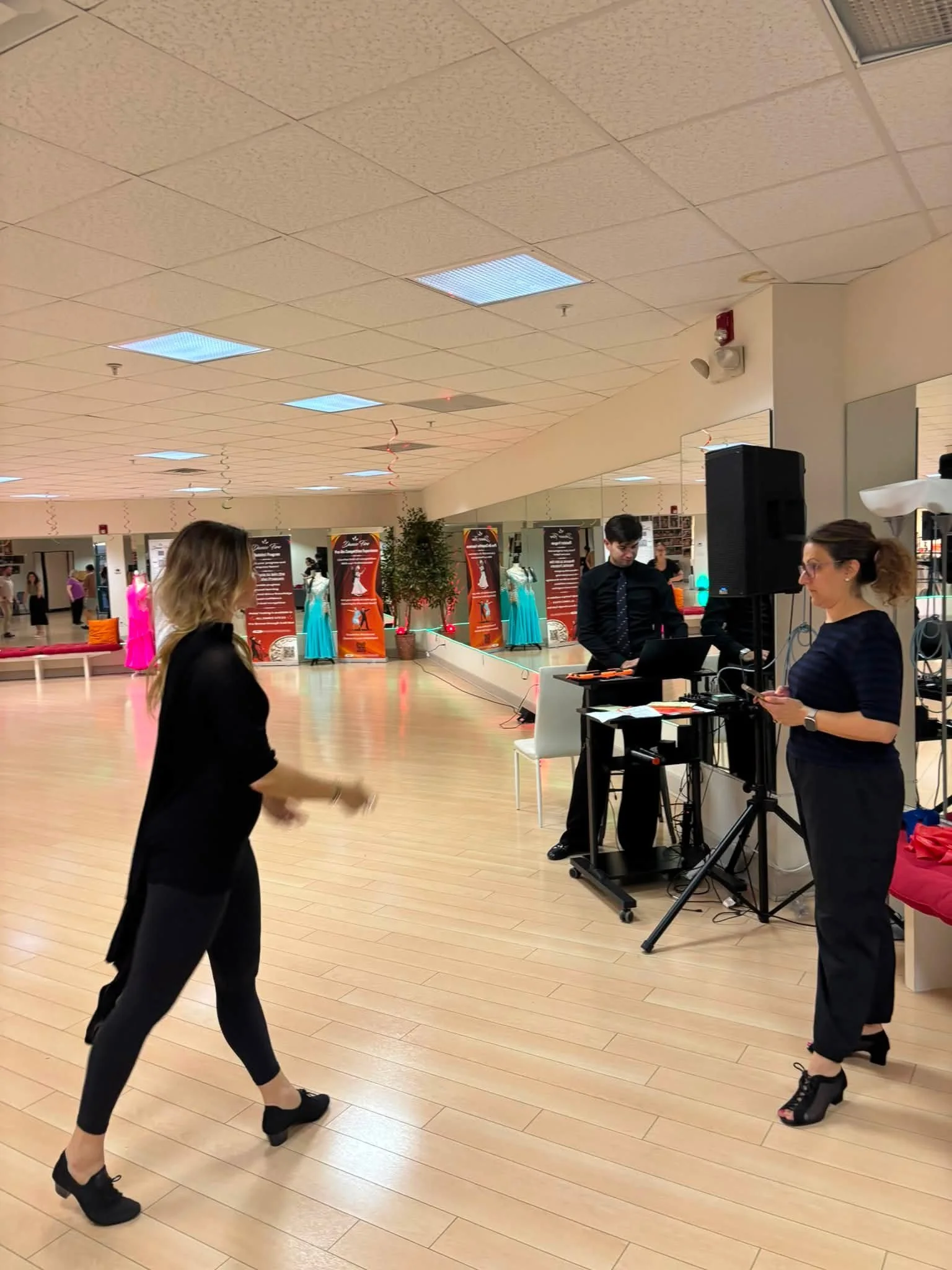 An instructor demonstrates movement as coaching participants watch