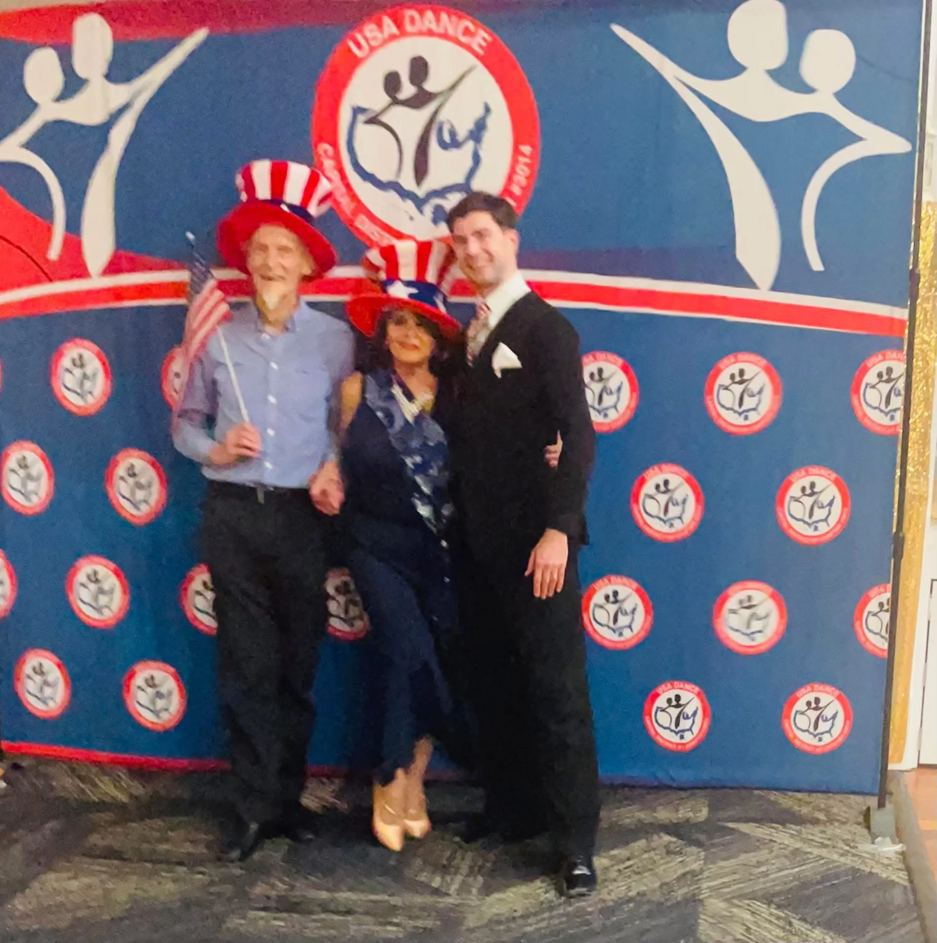 Showcase participants pose together in front of the USA Dance backdrop