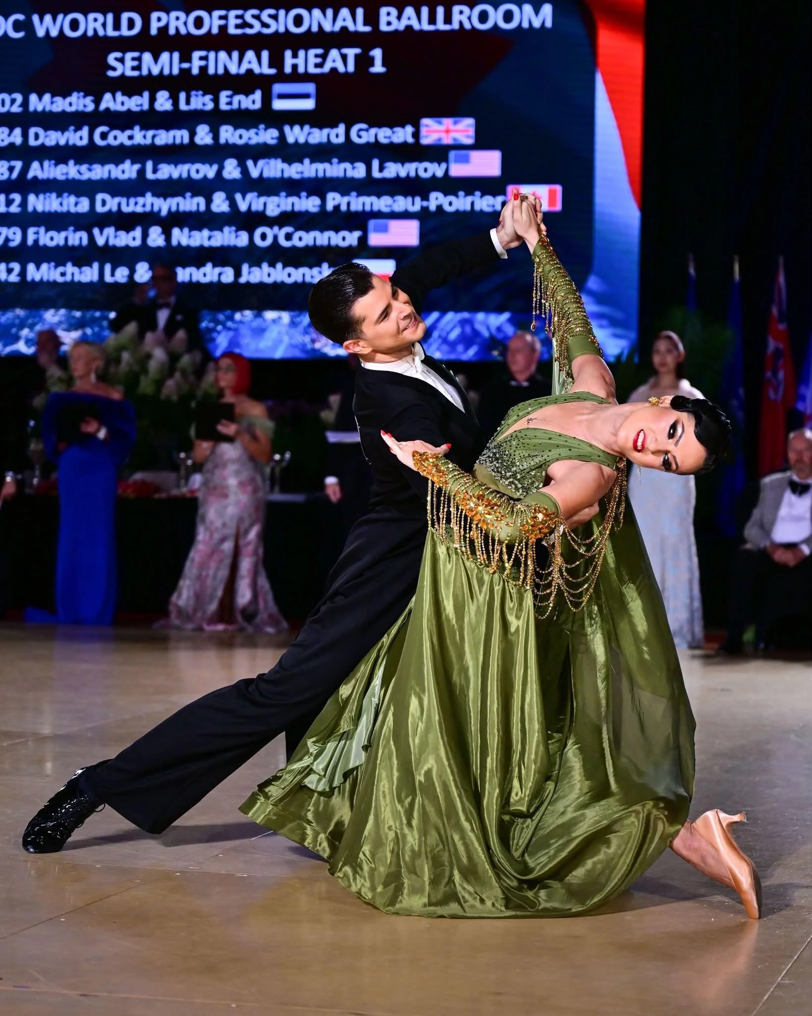 Florin supports Natalia in a sweeping ballroom pose during the World Championship