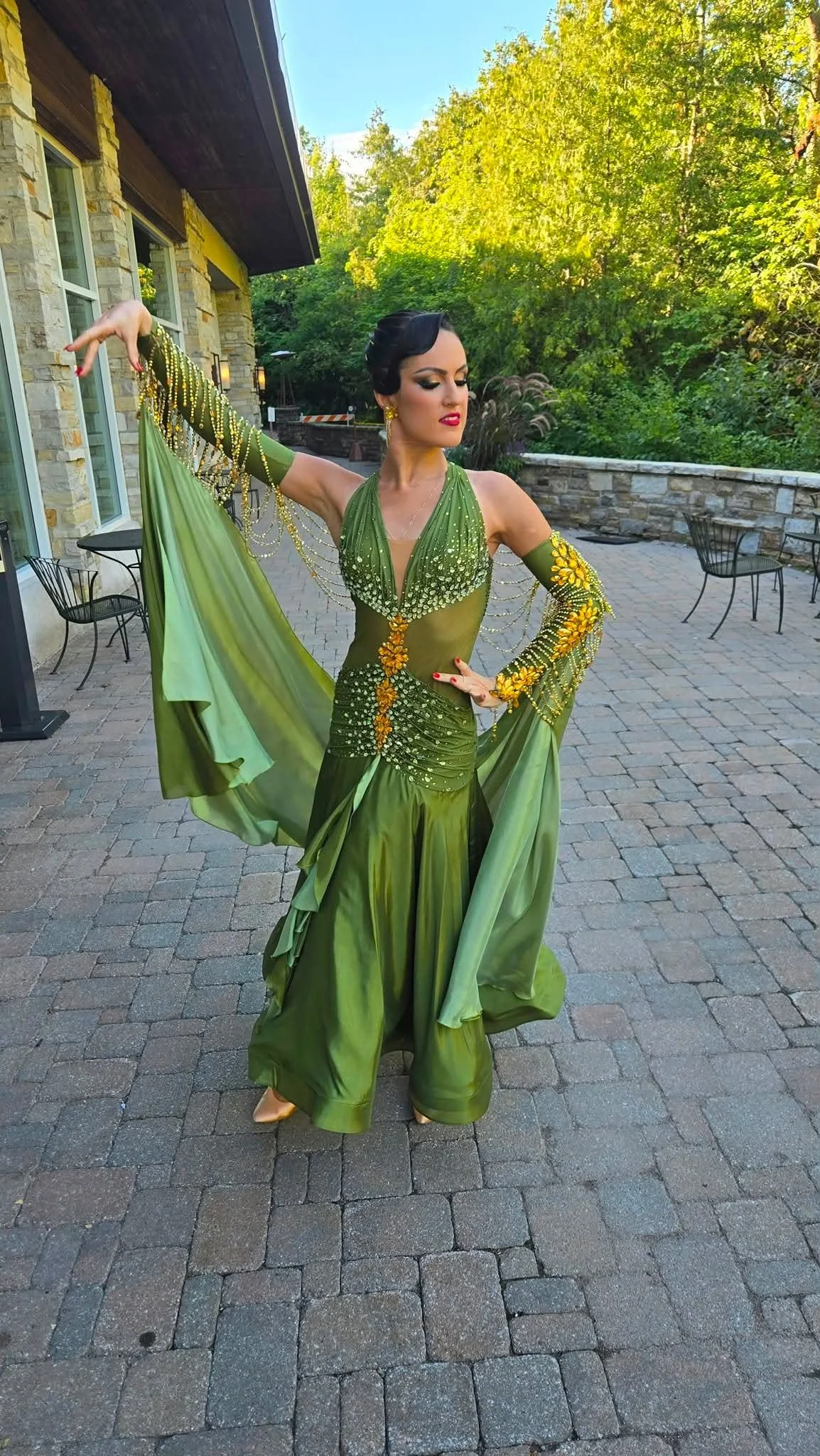 Natalia poses outdoors in her green ballroom dress