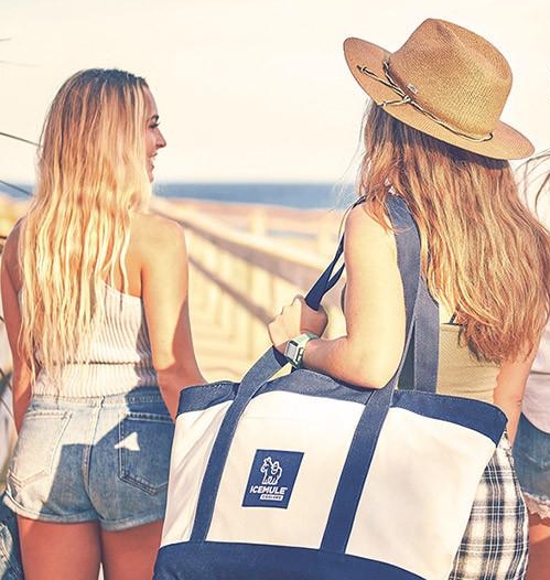 two women with an icemule tote headed to the beach