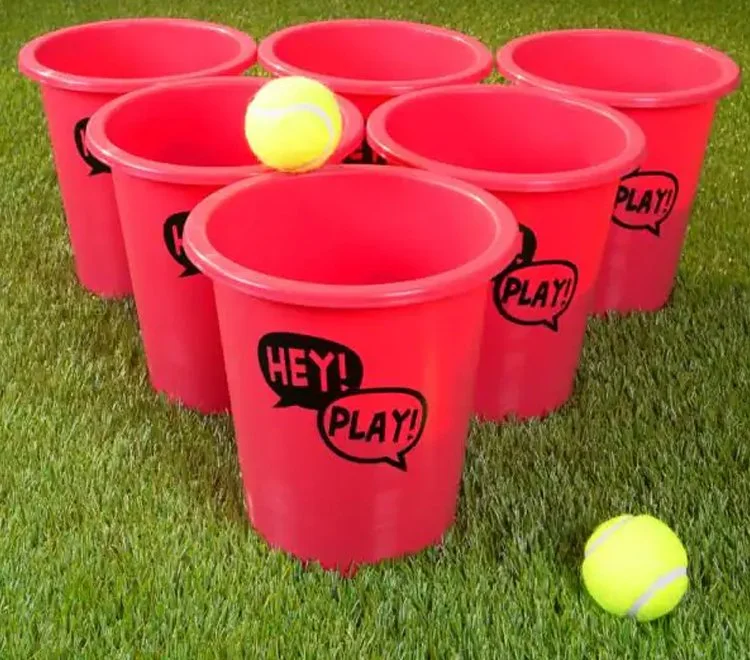 Bucket pong lawn game in use at a backyard party