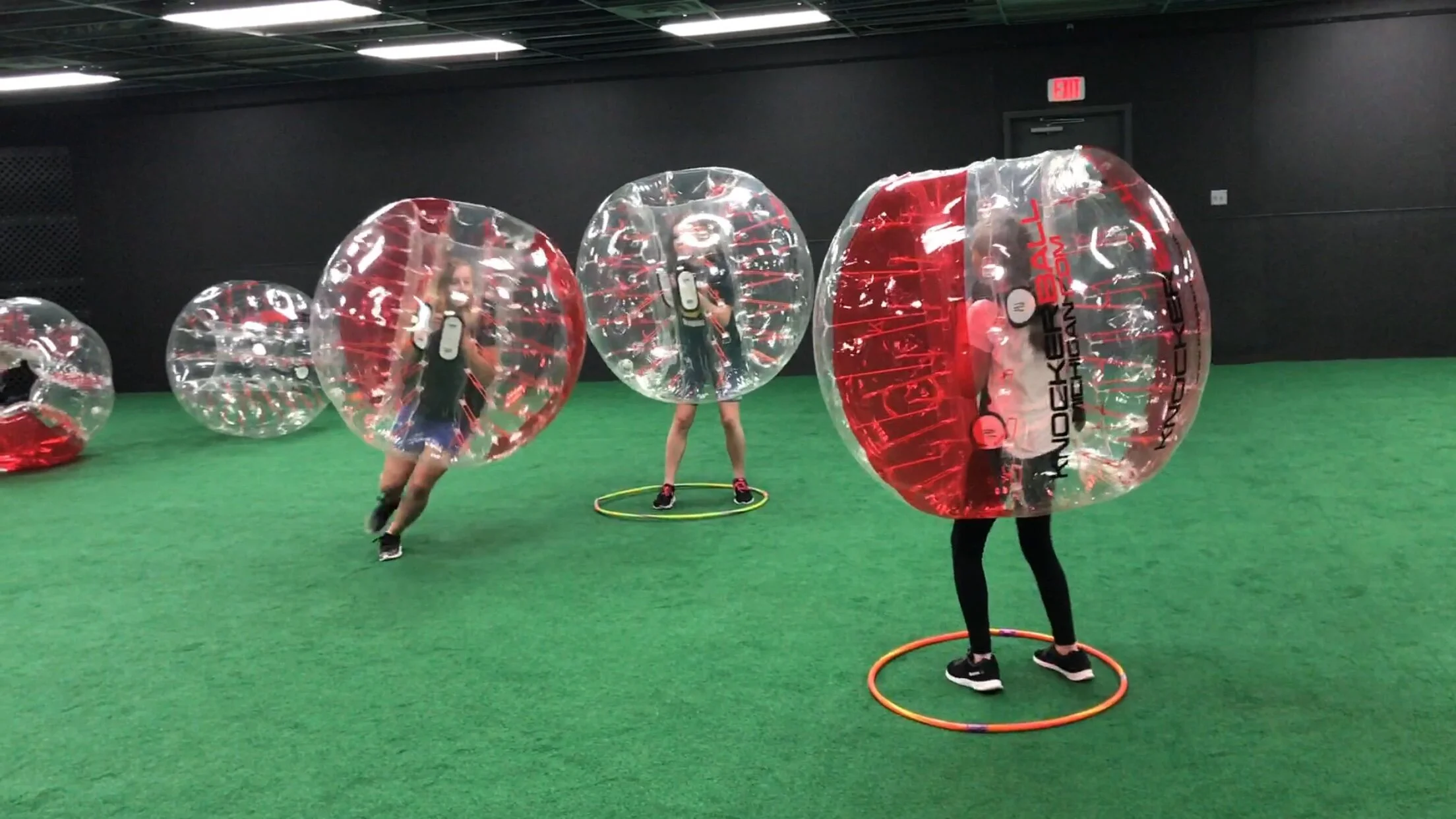 Participants in Knockerballs racing to step into hula hoops as music stops