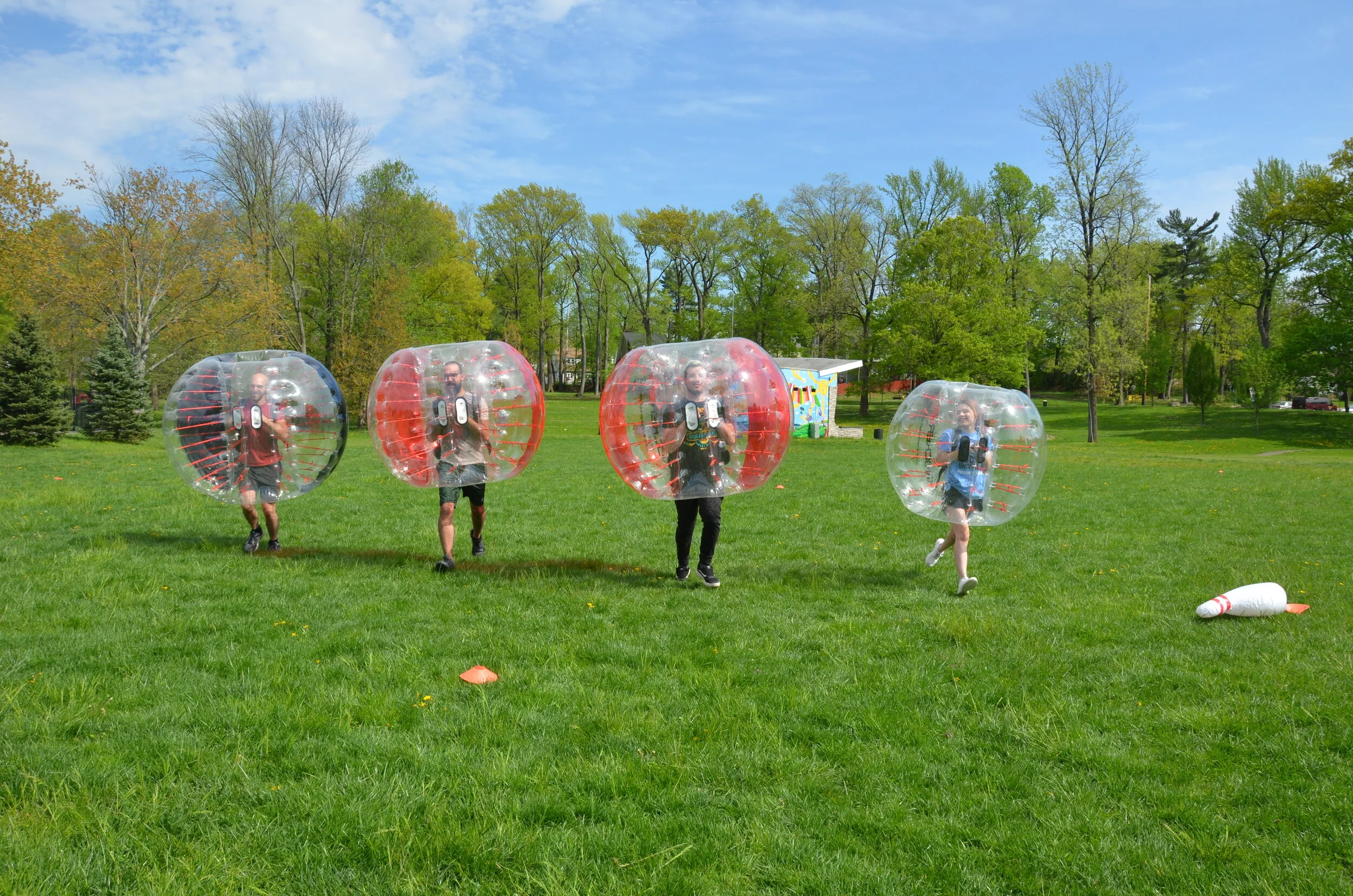 Teams of players in Knockerballs competing in a relay race on a field