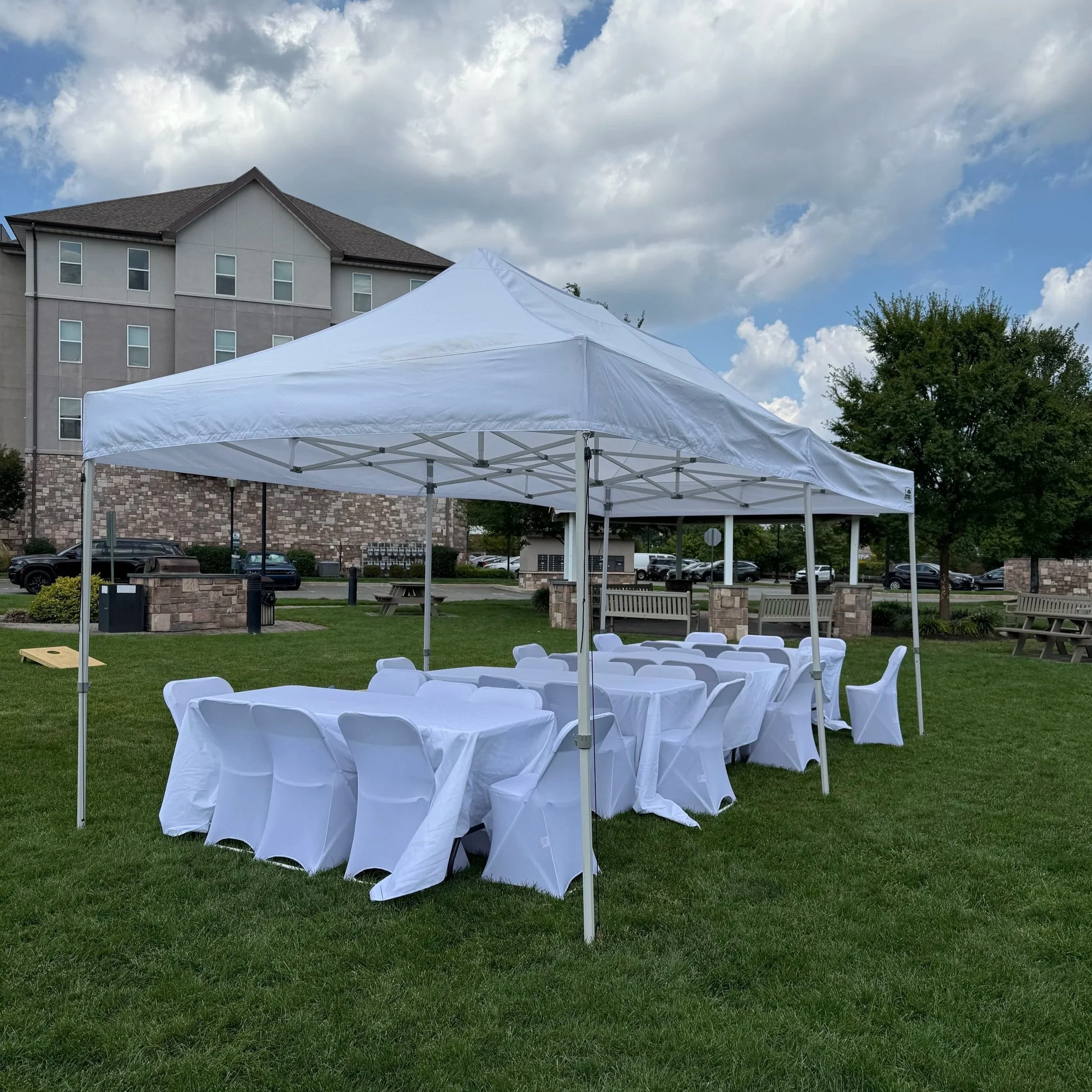 Party setup with 10x20 popup tent, tables and 32 chairs