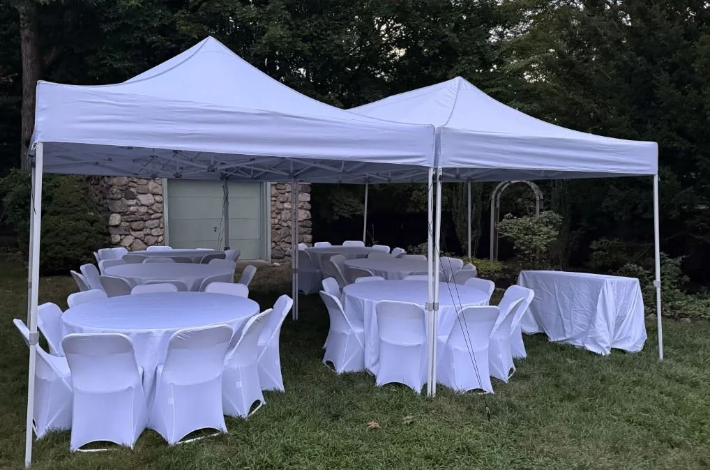 Outdoor 20x20 tent with tables and 64 chairs for event