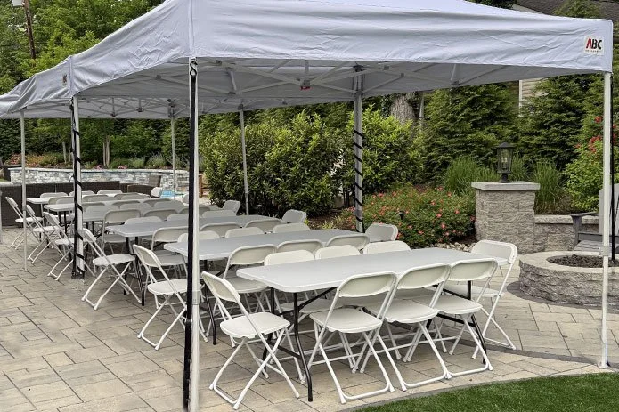 Tent table and chairs setup for an outdoor party event