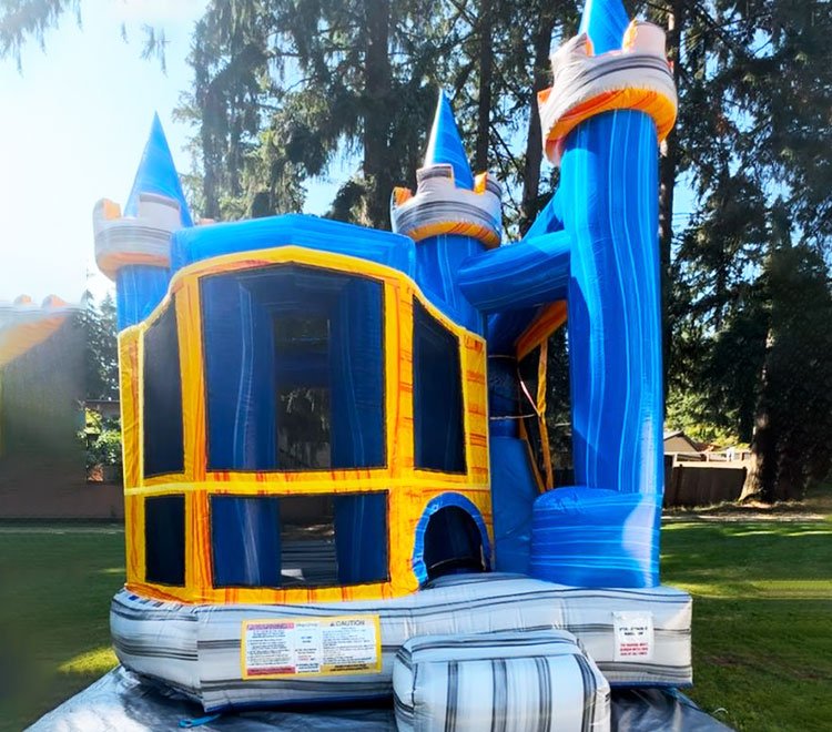 Castle-themed bounce house with attached slide for magical play