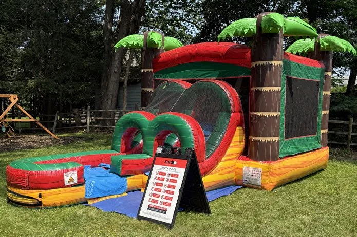 Inflatable slides and bounce houses set up for a party event