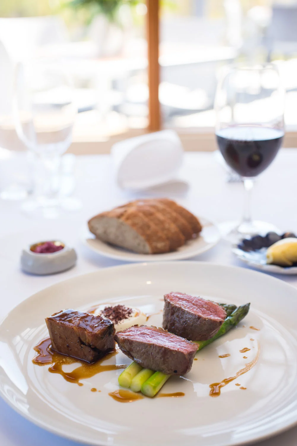 Roast lamb loin with slow cooked lamb shoulder and asparagus