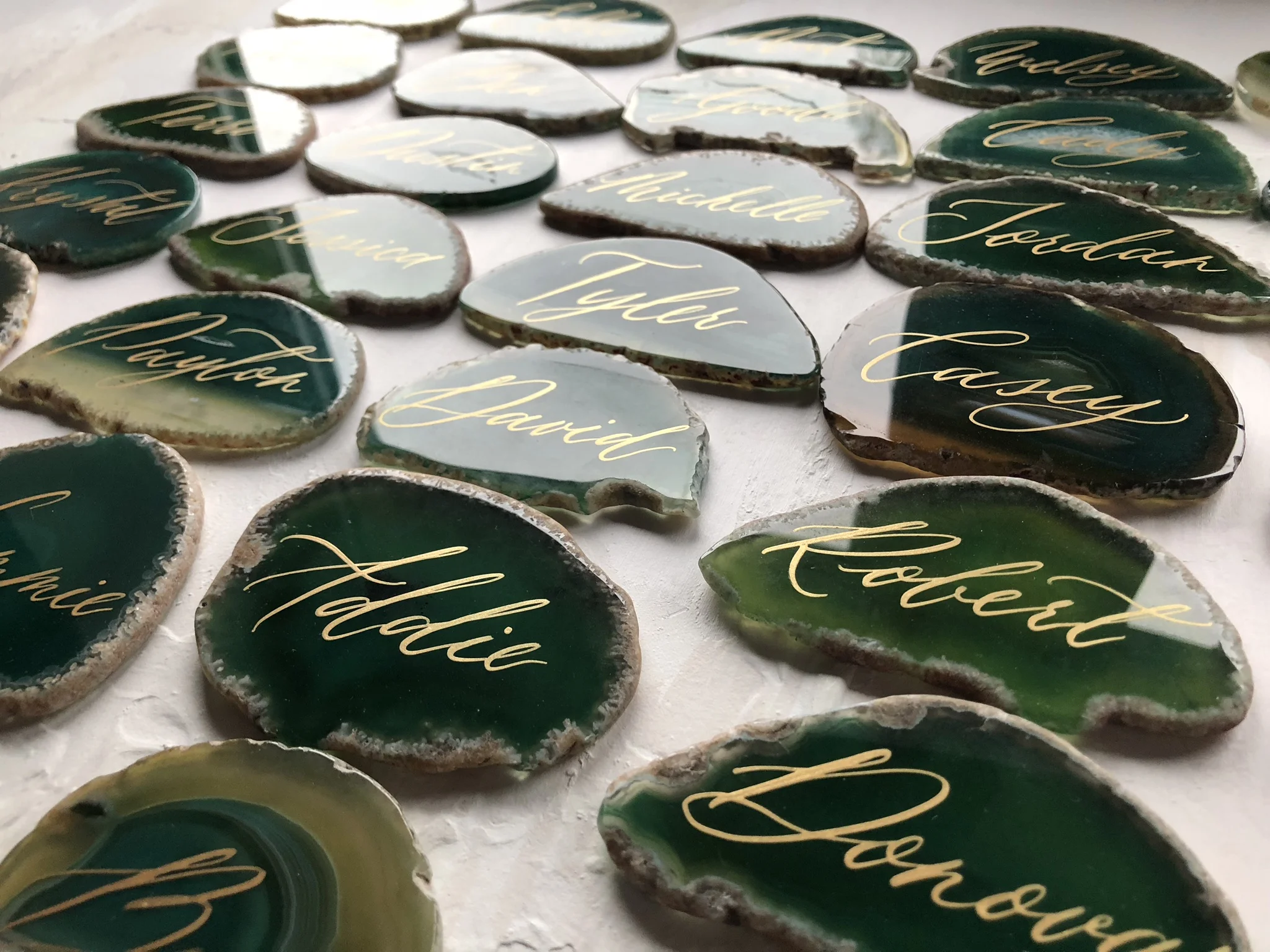 Gold calligraphy on green agate place cards