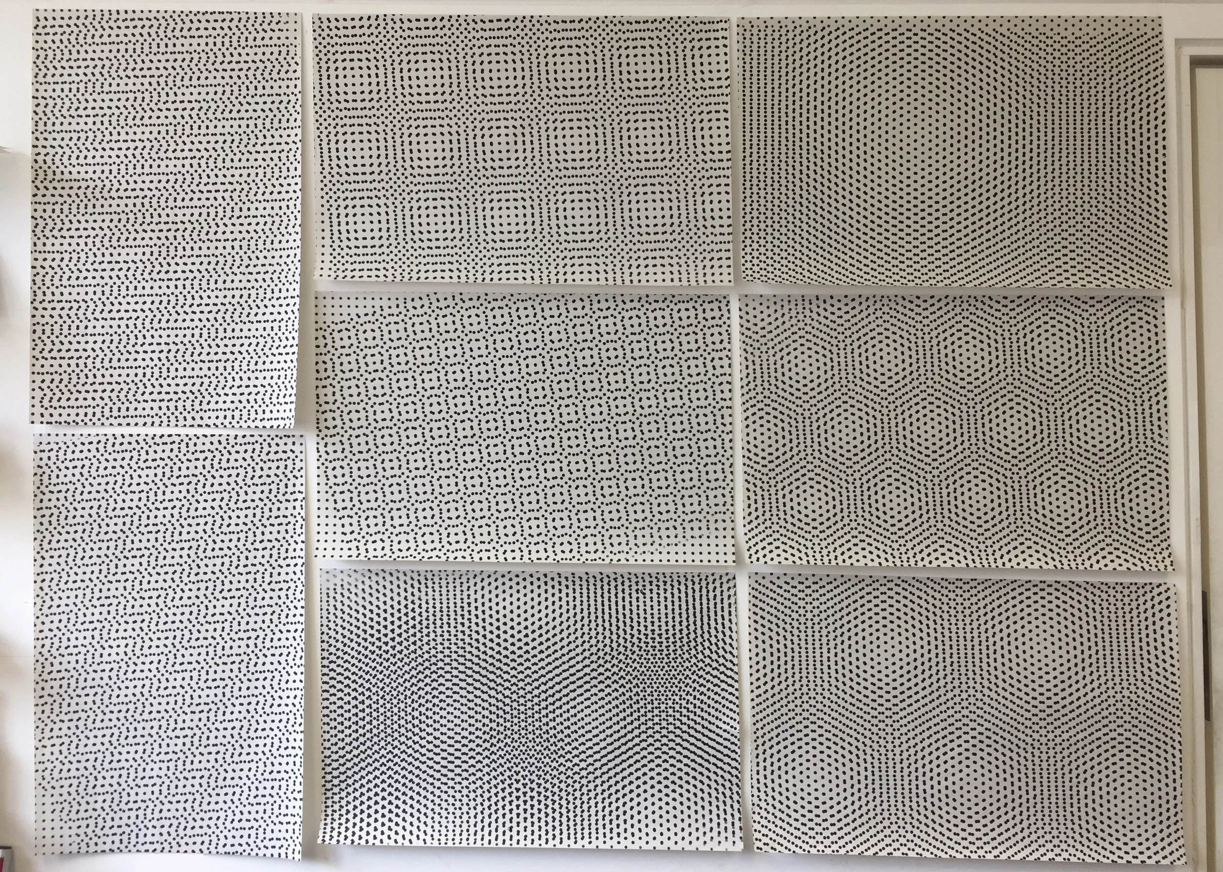 Print experiments on the studio wall.