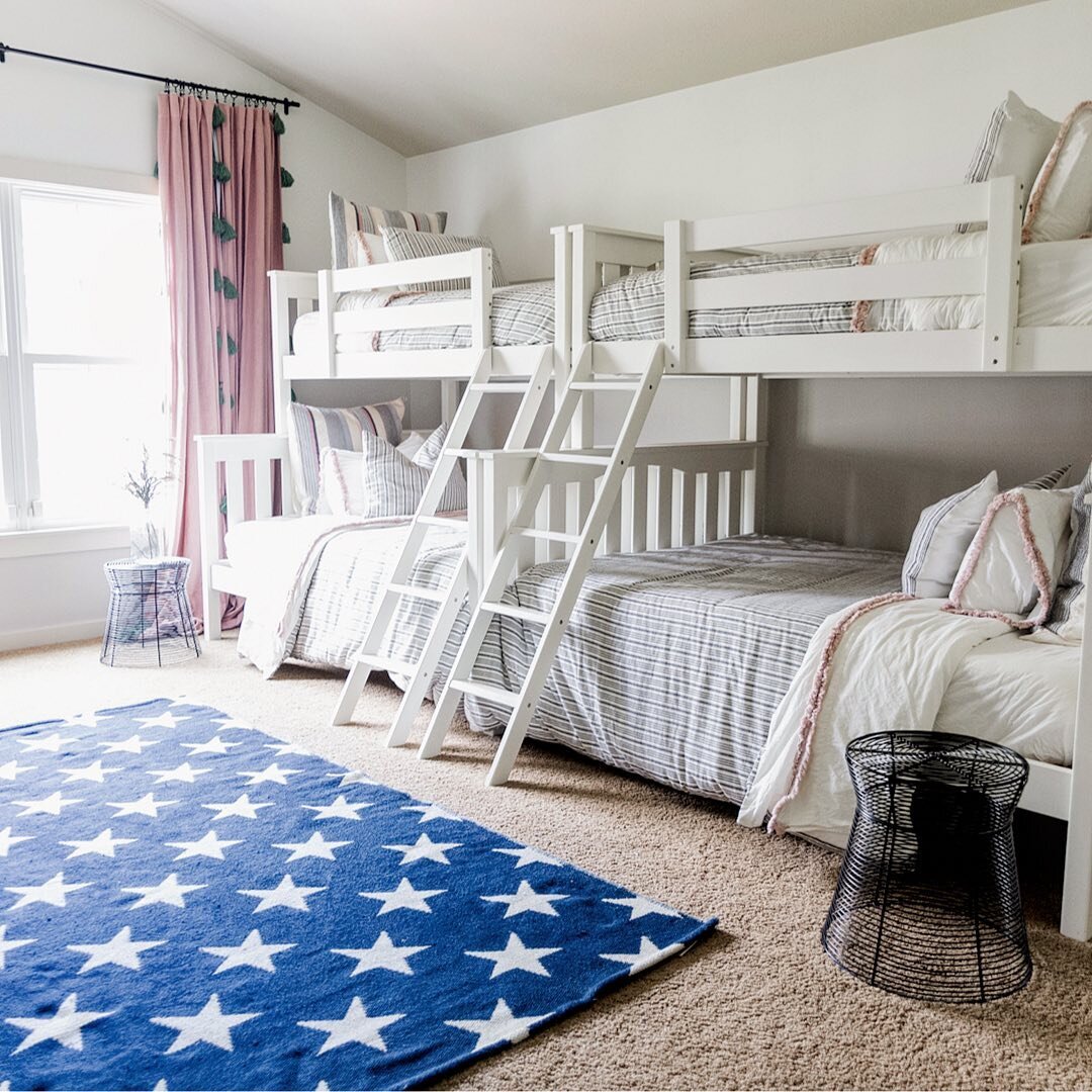 Bunk beds don't necessarily mean utilizing children's bedding.  In this case, a striped comforter with cream sheets create a bed that can be used for years.  Pair with some striped pillows and a little frill for texture and bam...a perfect place for 