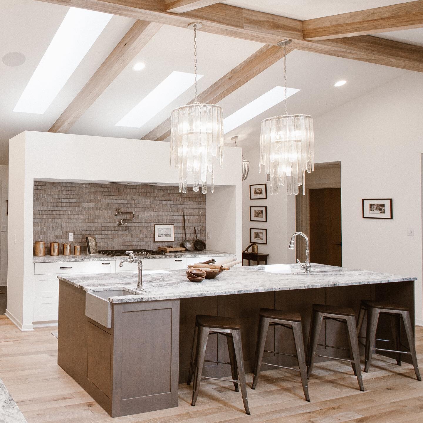 Our Weko Beach Project is one that took on a life of it's own, starting with a stark 90's look and chopped up layout (take a look at the second photo for the original). We reconfigured the entry + kitchen to capitalize on the amazing vaulted ceilings