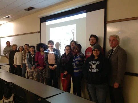 Professor Patricia Coughlan (picture of Irish writer Maeve Brennan reflected on her face) with students from Irish Women Writers, March 19, 2015